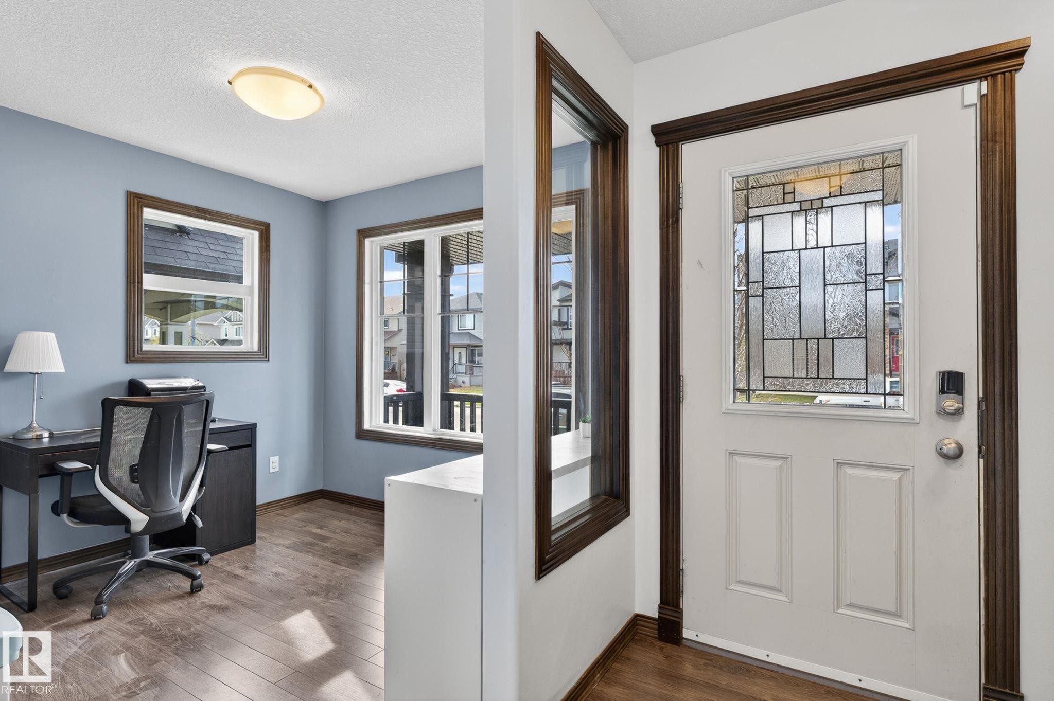 Entryway featuring a decorative glass panel door and rich wood-finish trim - 108 Hewitt Circle, Spruce Grove, AB - Indoor