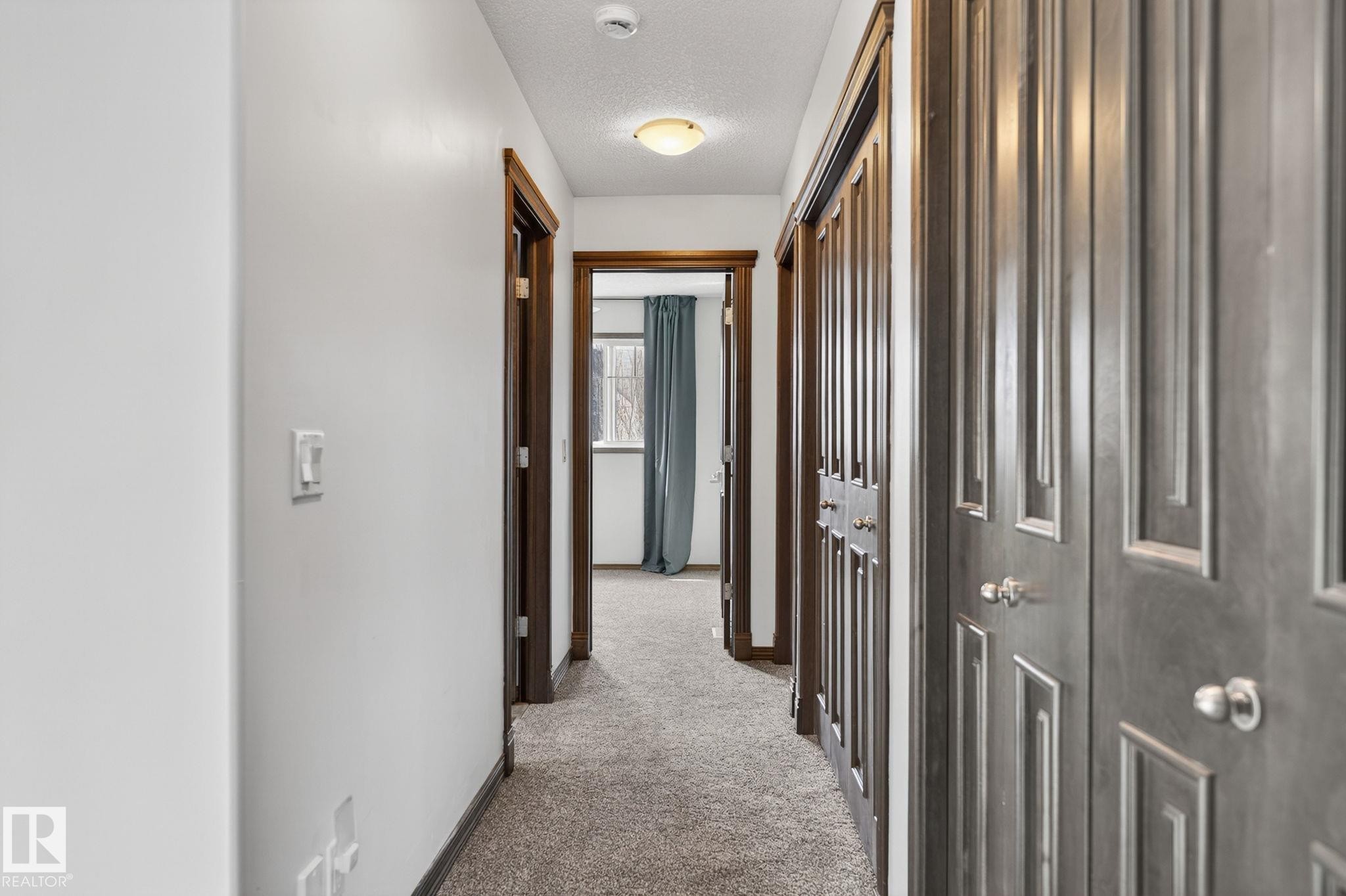 Hallway featuring light-colored carpeting and white walls - 108 Hewitt Circle, Spruce Grove, AB - Indoor Photo Showing Other Room