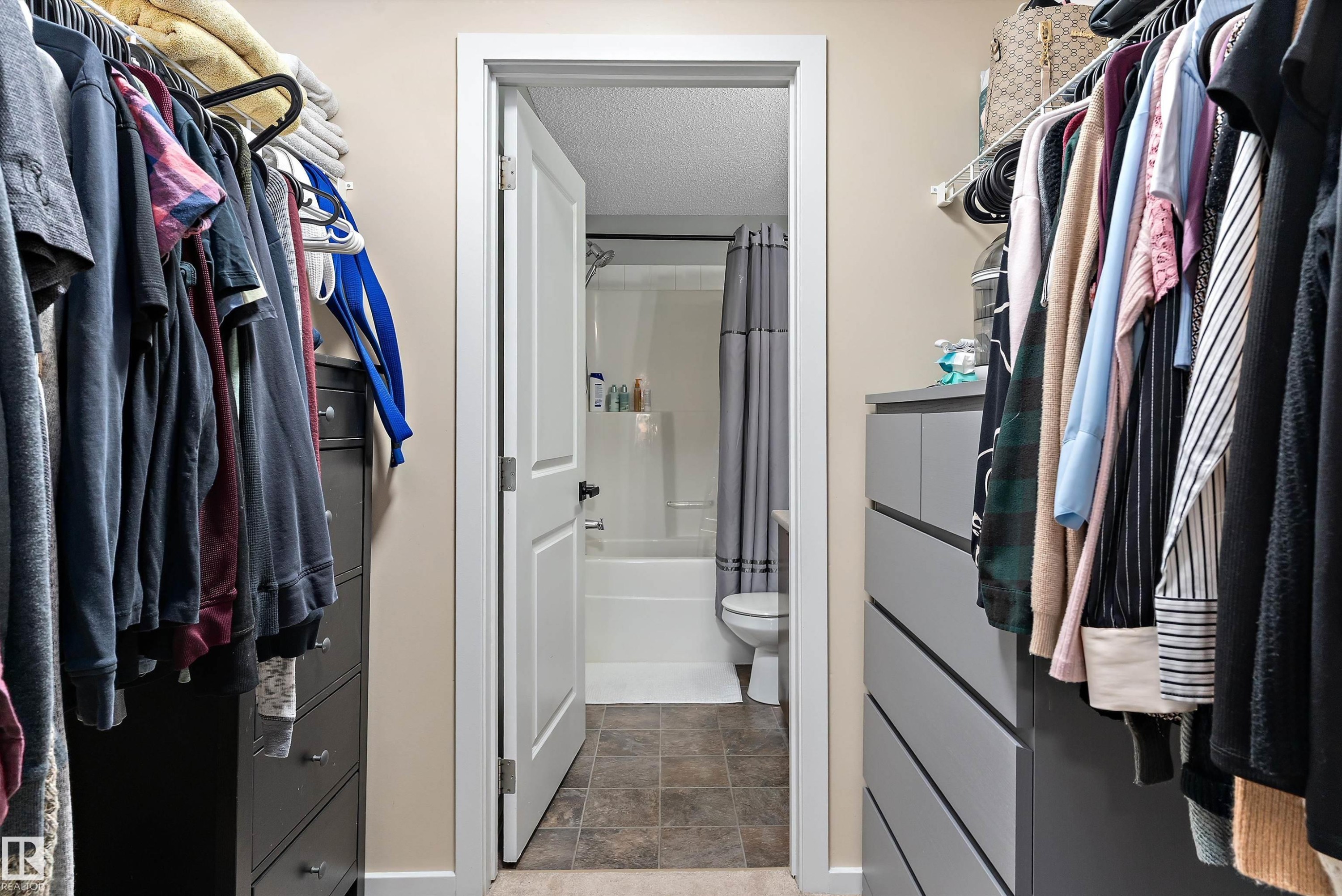 Walk-in closet with built-in shelving, hanging rods, and integrated drawer storage - 122 3357 16A Avenue, Edmonton, AB - Indoor With Storage