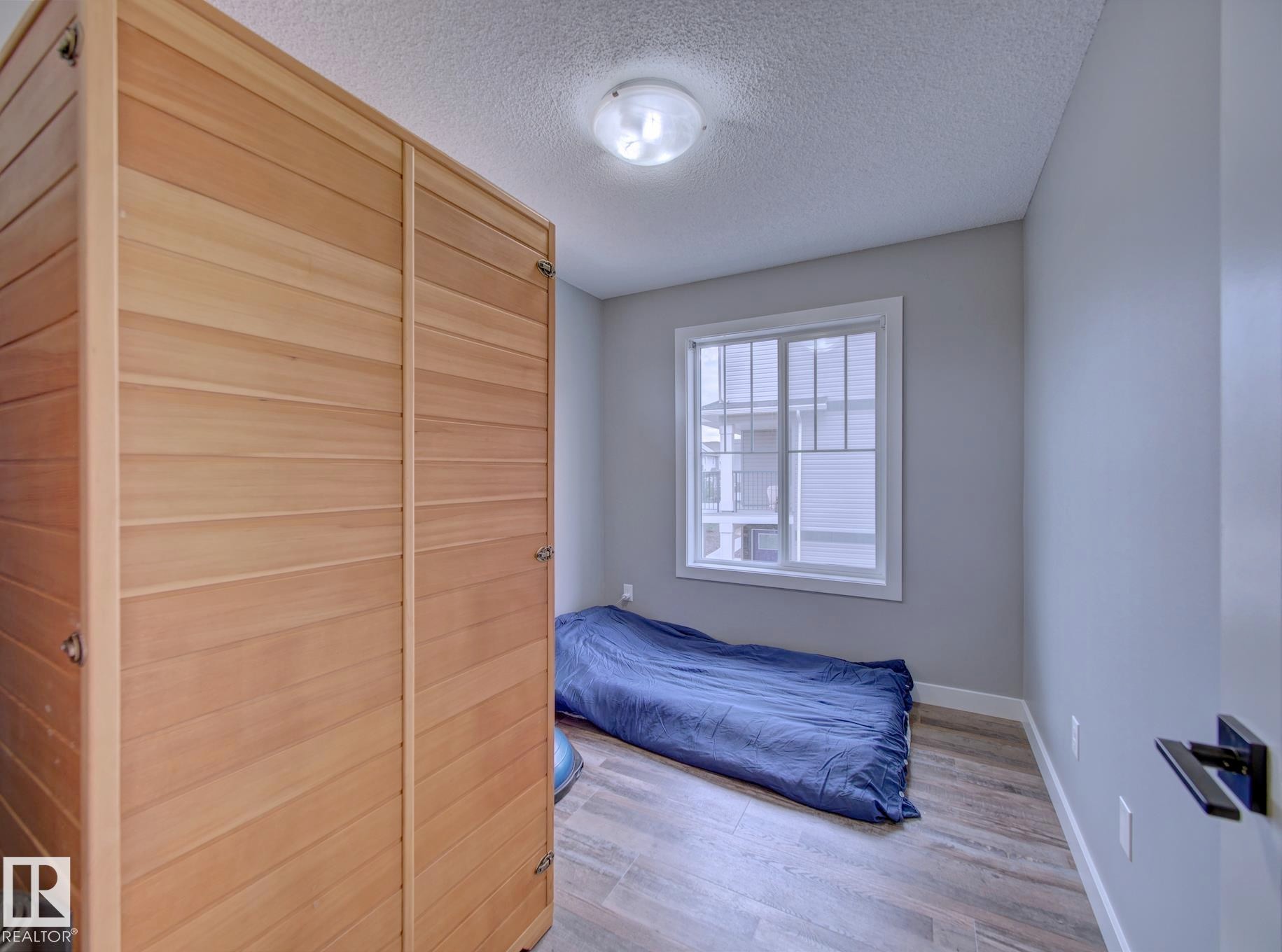 Light wood-paneled sauna featuring a contrasting dark wood base - 11 165 Cy Becker Boulevard, Edmonton, AB - Indoor