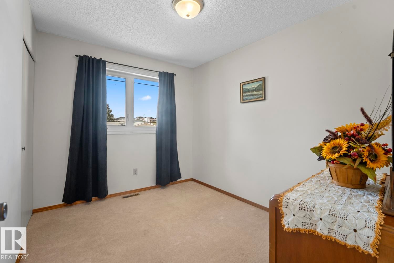 Carpeted interior room with white walls, a single window, and a flush mount ceiling light fixture - 1304 12 Street, Cold Lake, AB - Indoor Photo Showing Other Room
