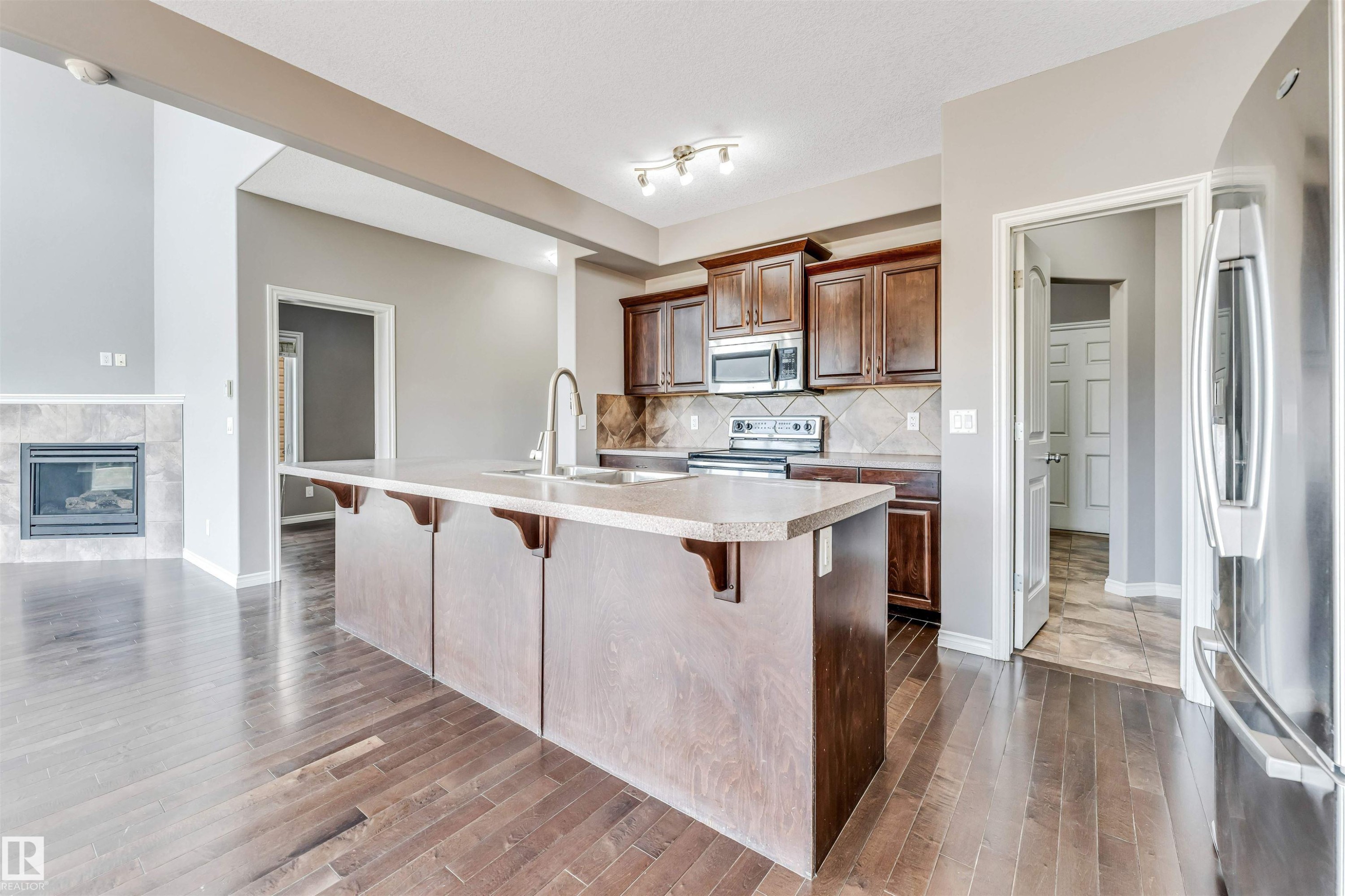 Kitchen island with an undermount sink and a gooseneck faucet - 2138 32B Street, Edmonton, AB - Indoor Photo Showing Kitchen