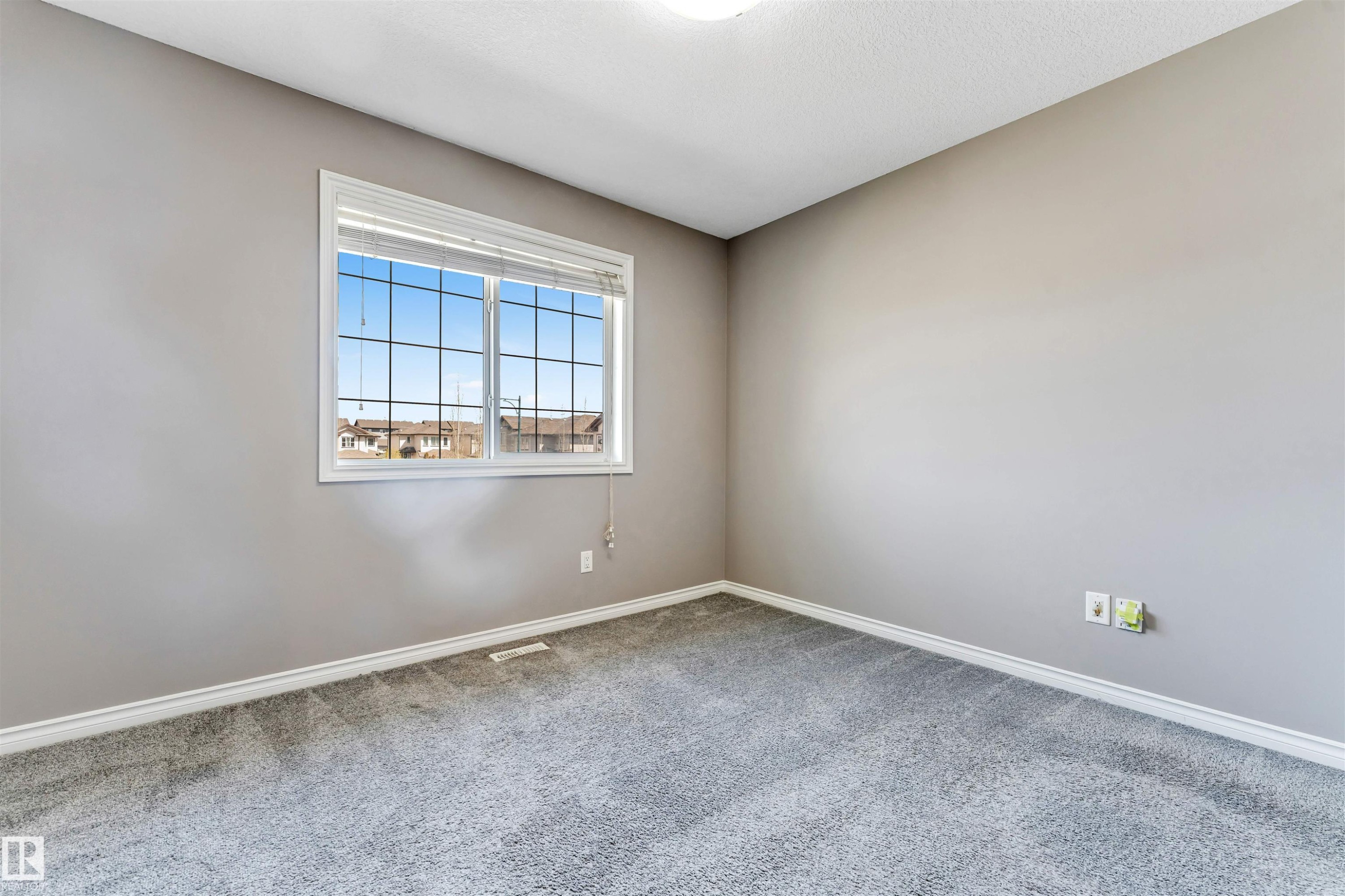 Carpeted room with a multi-pane window and neutral wall paint - 2138 32B Street, Edmonton, AB - Indoor Photo Showing Other Room