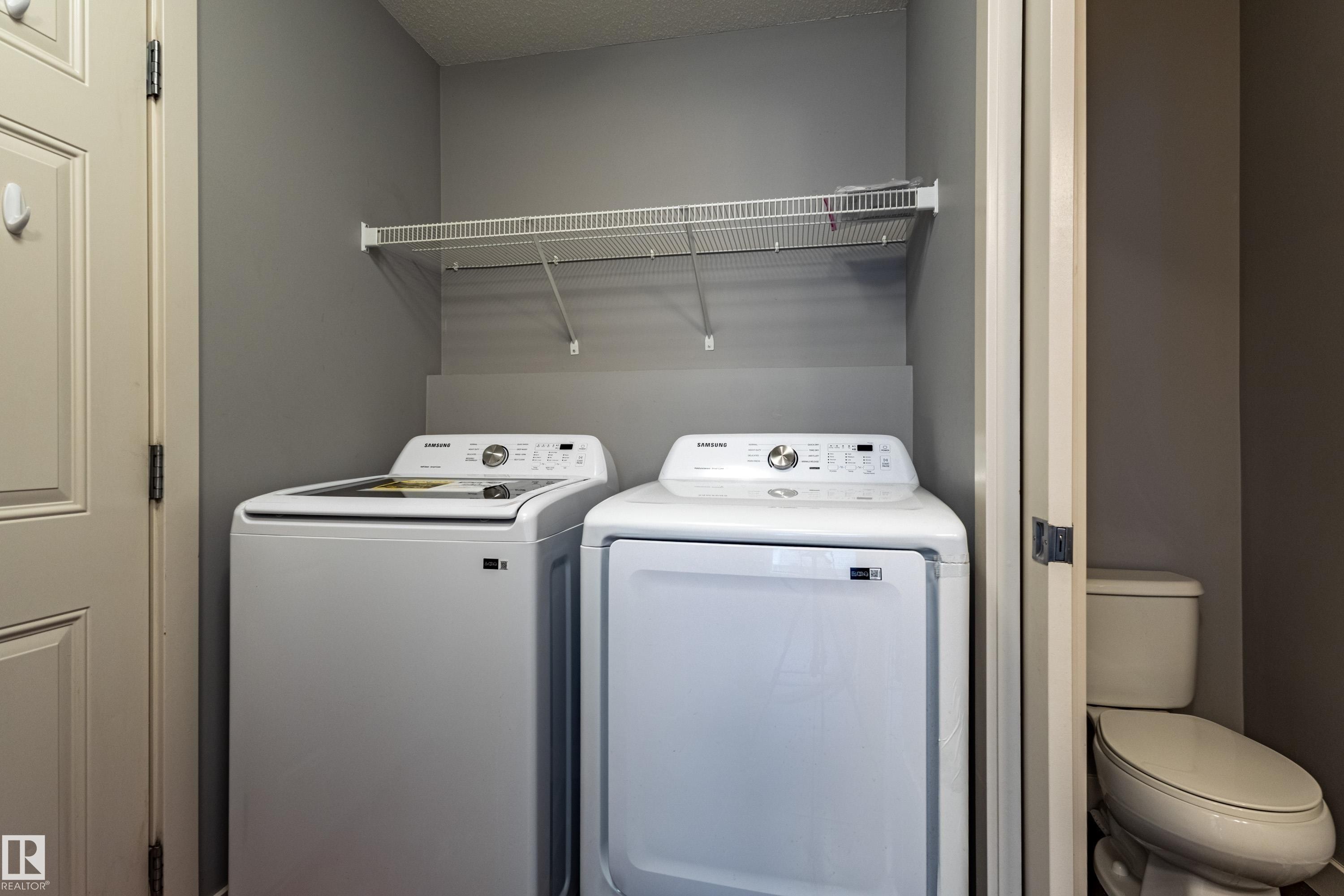Laundry area featuring a top-load washer, front-load dryer, and overhead wire shelving - 17715 6 Avenue, Edmonton, AB - Indoor Photo Showing Laundry Room