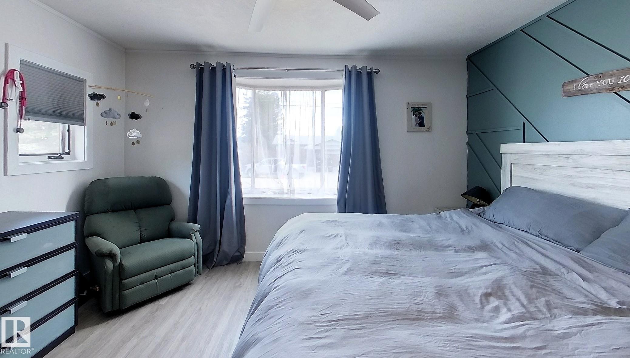 Light wood-finish flooring - 7126 4A Ave, Edson, AB - Indoor Photo Showing Bedroom