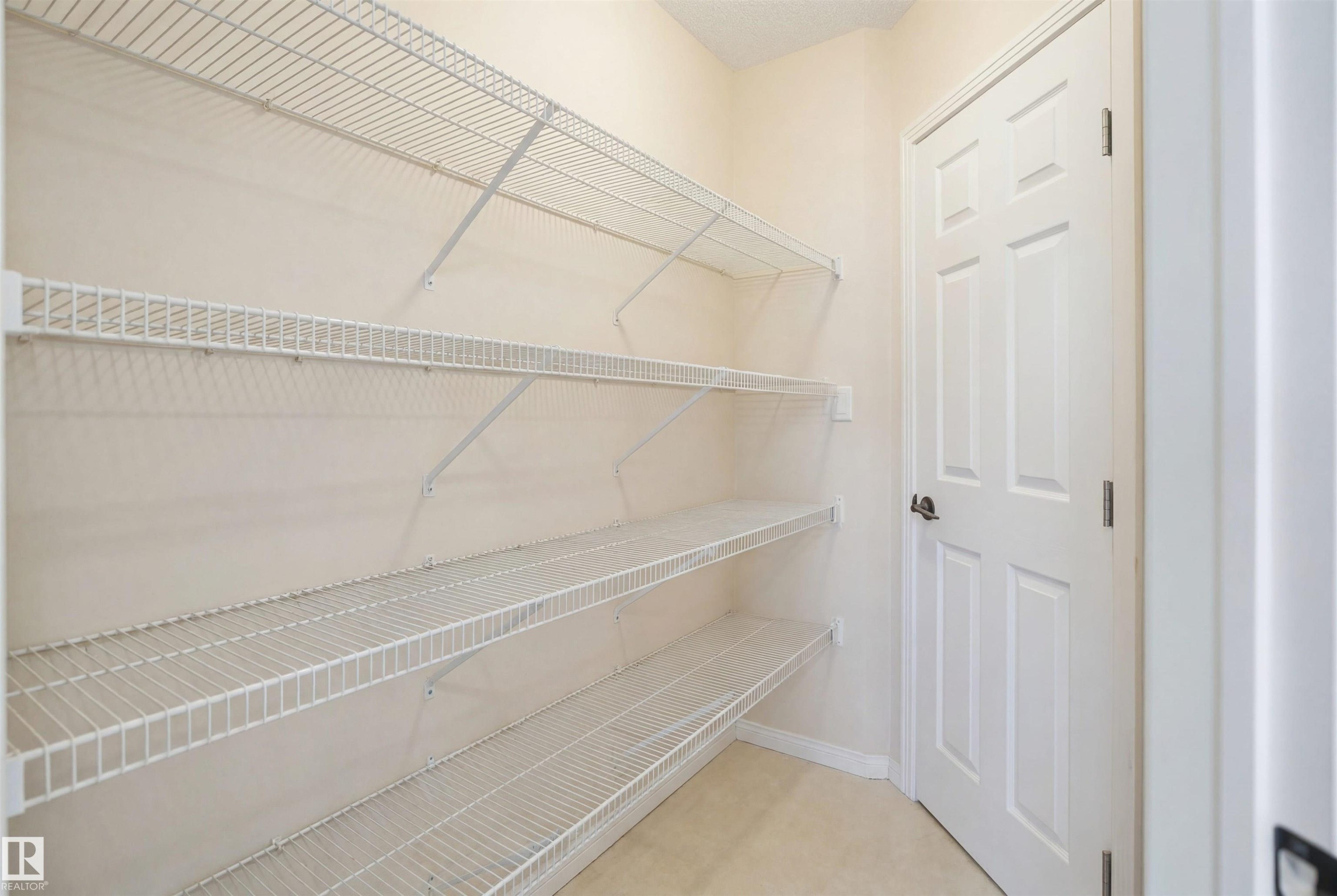Interior storage area featuring light-colored walls and multiple levels of wire shelving - 1453 Hays Way Nw, Edmonton, AB - Indoor With Storage