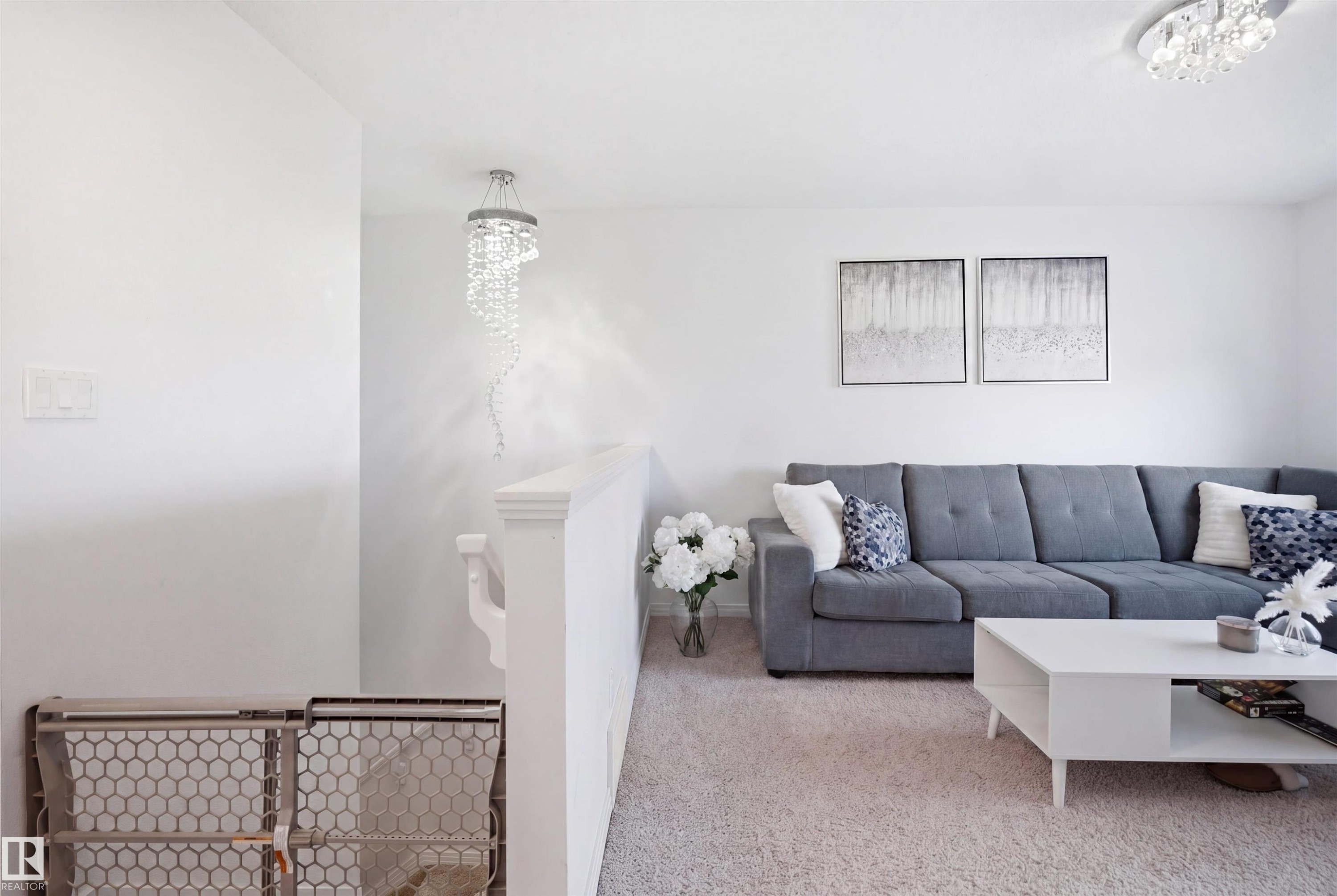 Bright living area featuring light-toned carpeting and white walls - 1453 Hays Way Nw, Edmonton, AB - Indoor Photo Showing Living Room
