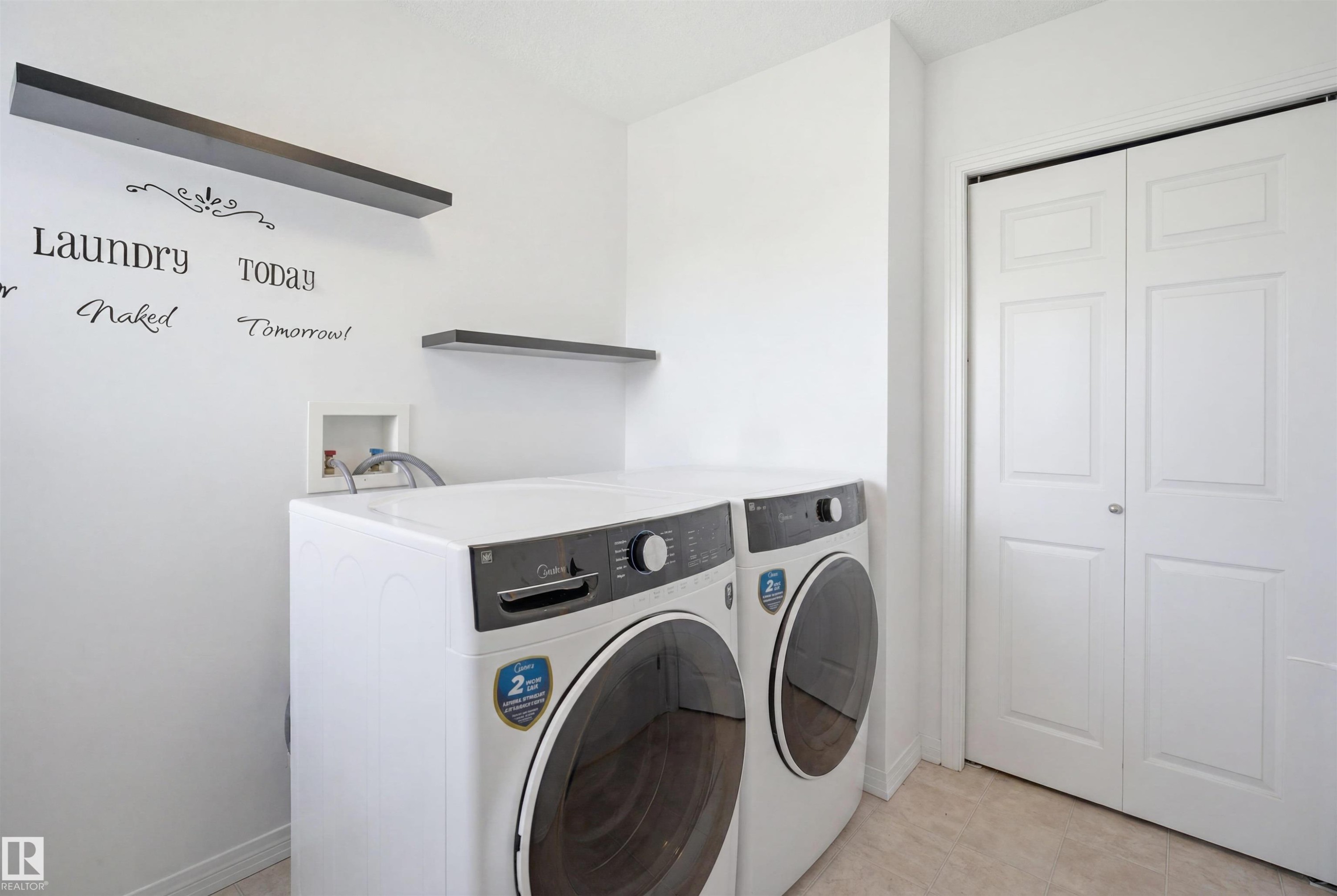 Dedicated laundry space featuring neutral-toned flooring and white walls - 1453 Hays Way Nw, Edmonton, AB - Indoor Photo Showing Laundry Room