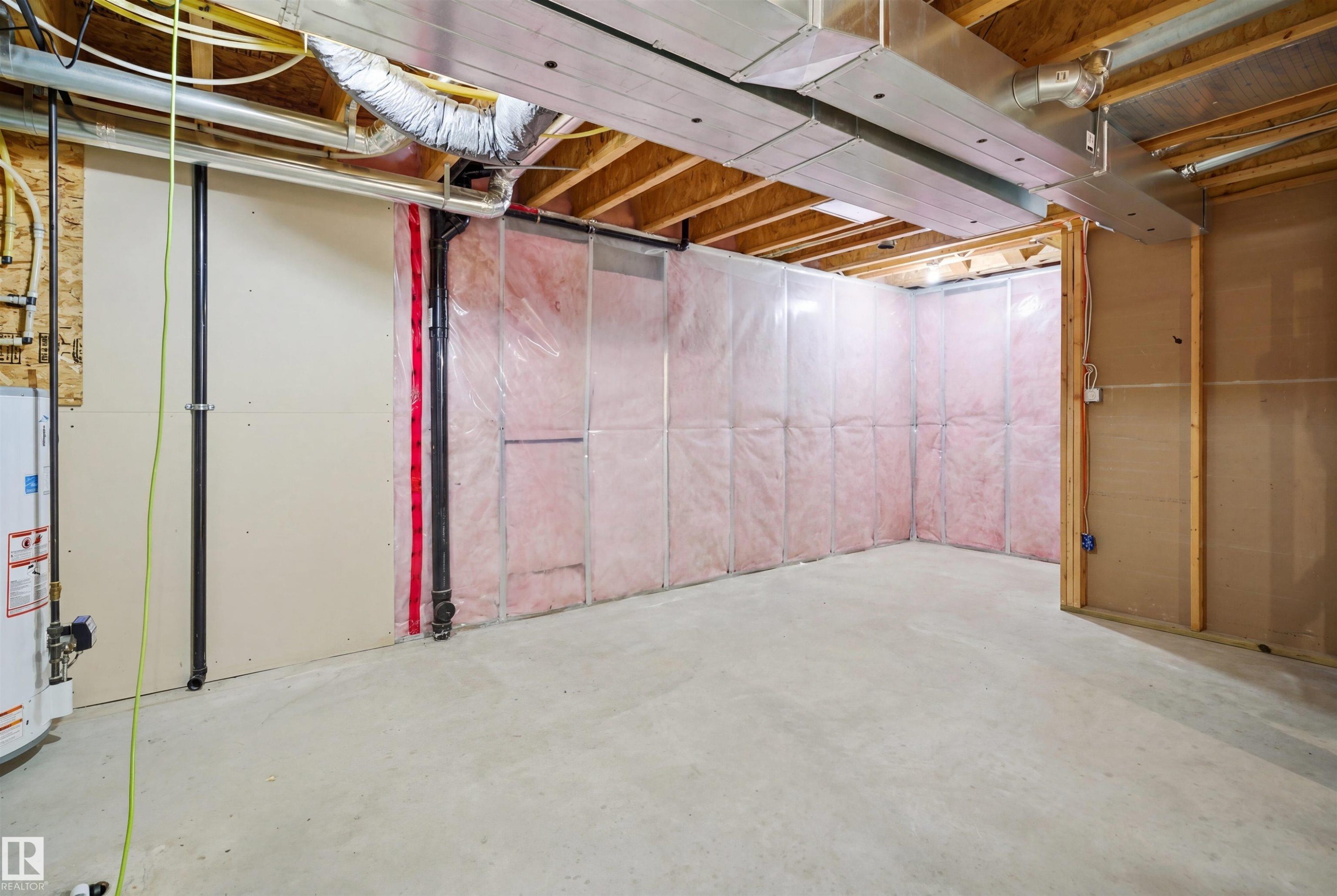 Unfinished lower level with concrete flooring, exposed ceiling joists, and visible ductwork and plumbing - 1453 Hays Way Nw, Edmonton, AB - Indoor Photo Showing Basement