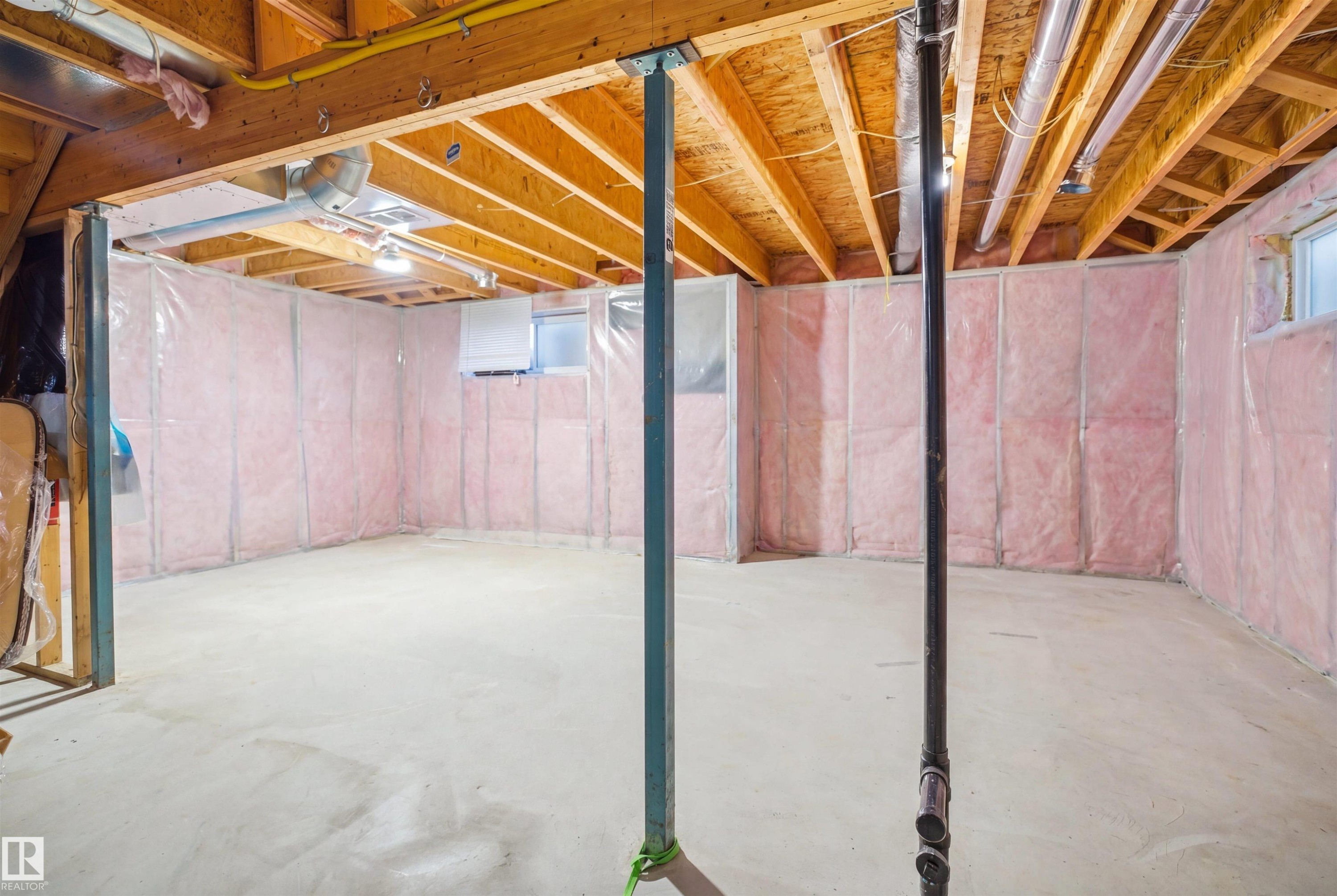 Unfinished basement featuring exposed wood joists, concrete flooring, and insulated walls - 1453 Hays Way Nw, Edmonton, AB - Indoor Photo Showing Basement