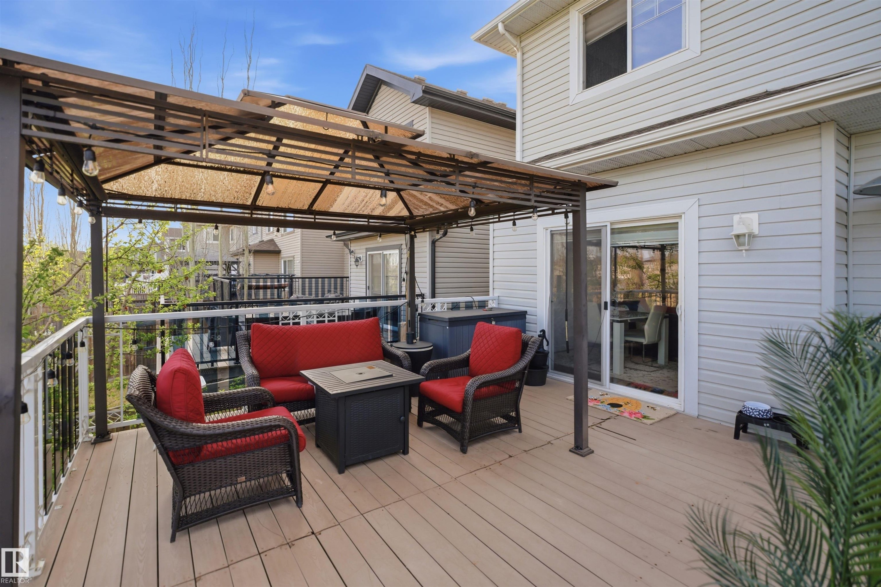 Expansive outdoor deck featuring composite decking, a permanent gazebo structure with integrated lighting, and white perimeter railing with black balusters - 1453 Hays Way Nw, Edmonton, AB - Outdoor With Deck Patio Veranda With Exterior