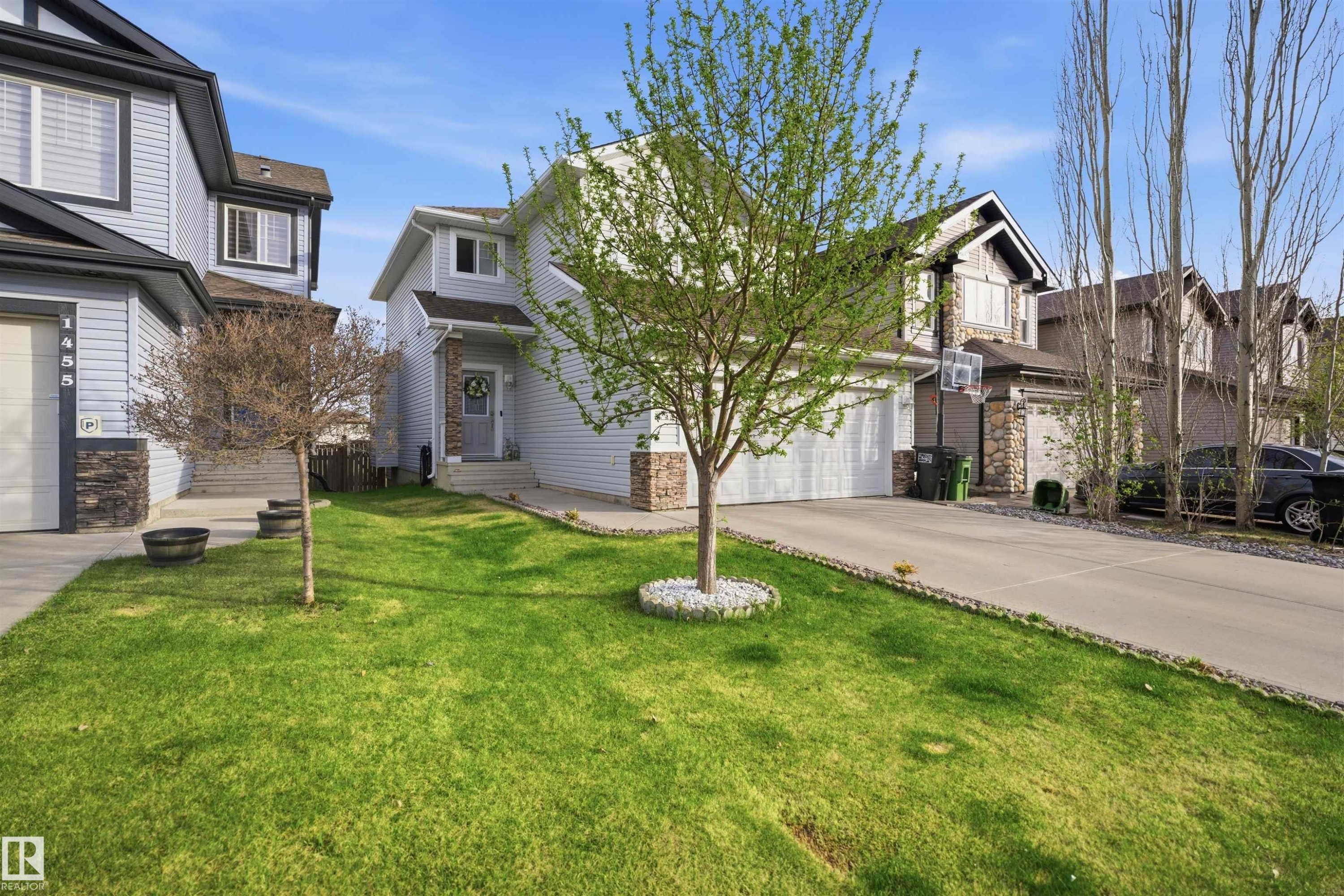 Light blue siding exterior with stone accents and a covered front entry - 1453 Hays Way Nw, Edmonton, AB - Outdoor With Facade