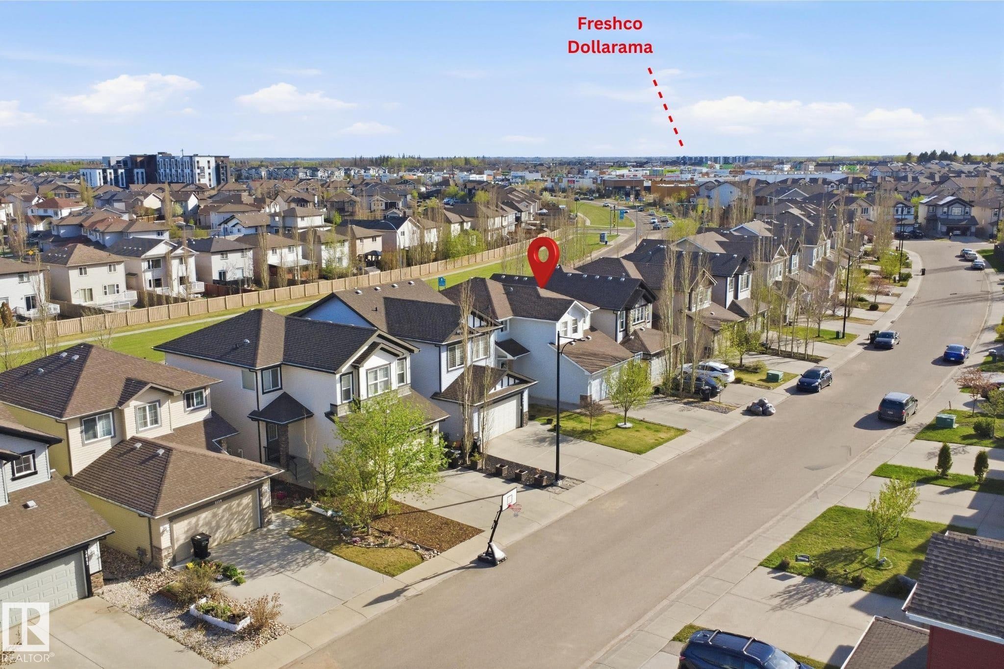 Aerial view showcasing a residential street with detached homes, each featuring a private driveway and attached garage - 1453 Hays Way Nw, Edmonton, AB - Outdoor With View