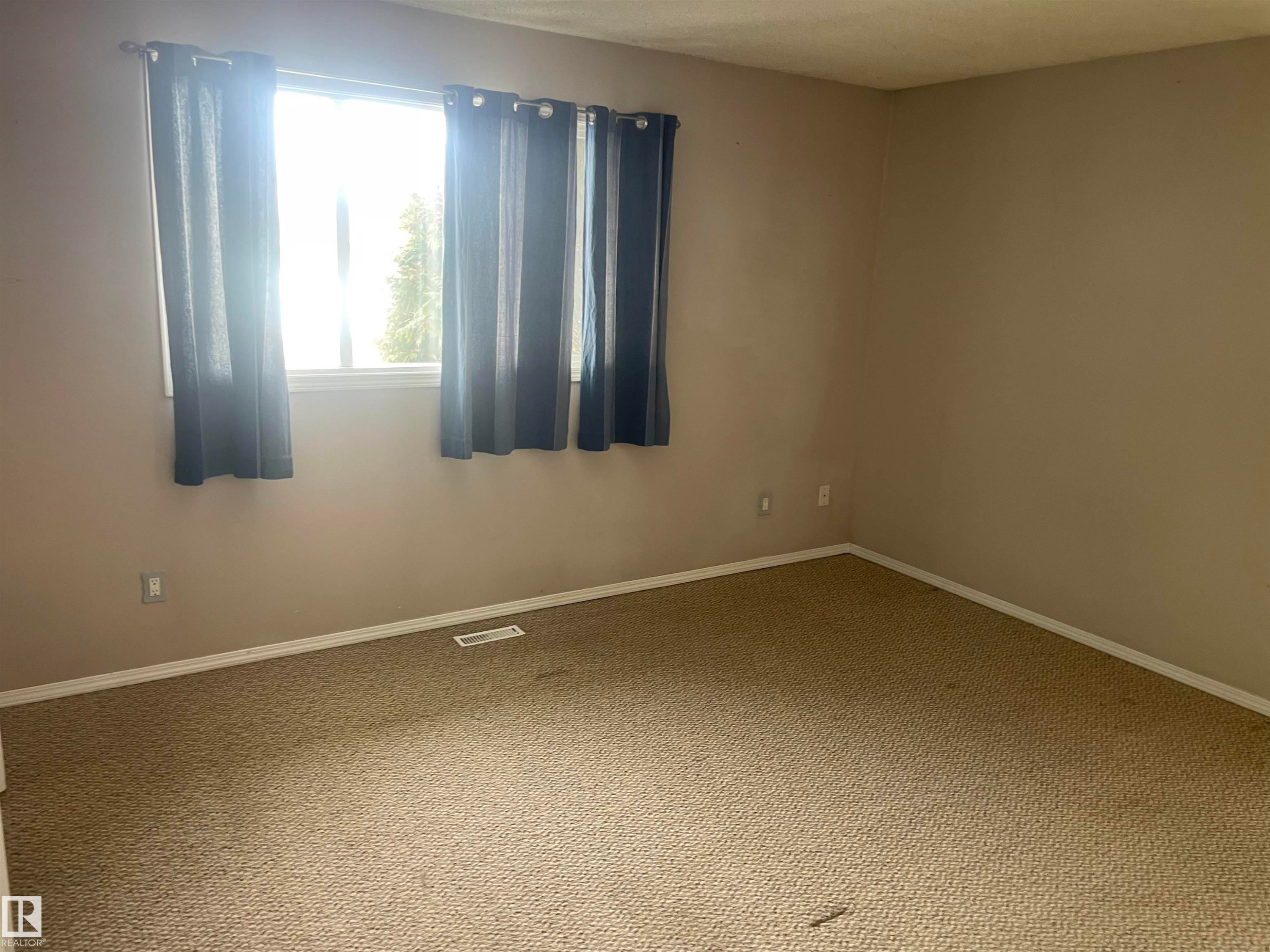This room features a window providing natural light, neutral-toned walls, and carpeting - 2629 129A Avenue, Edmonton, AB - Indoor Photo Showing Other Room