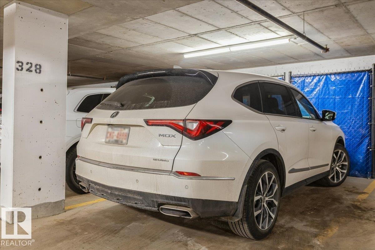 HEATED UNDER GROUND PARKING STALL WITH STORAGE CAGE - 428 7463 May Common, Edmonton, AB - Indoor Photo Showing Garage
