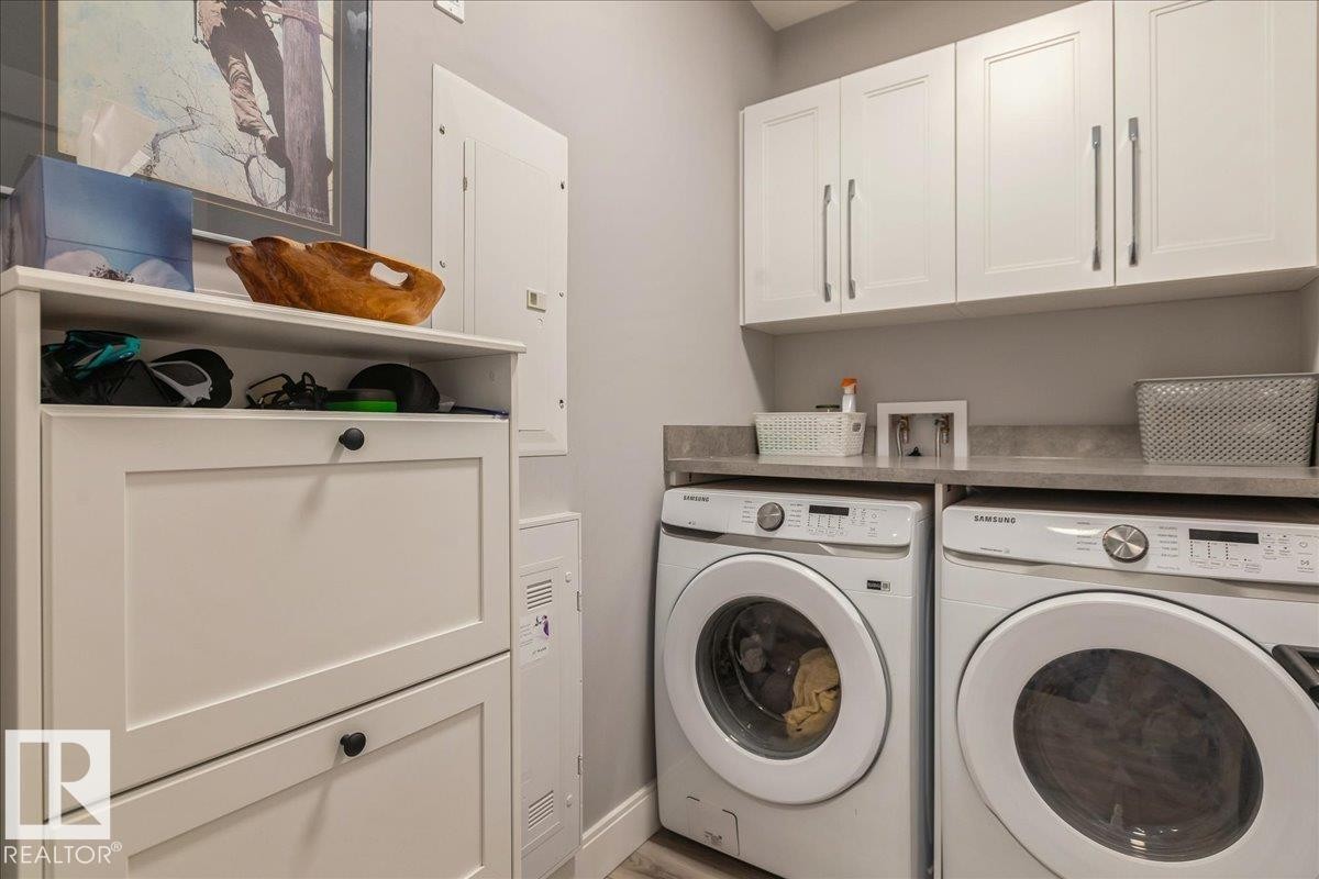 LARGE LAUNDRY ROOM WITH COUNTERTOP AND CABINETS - 405 7463 May Common, Edmonton, AB - Indoor Photo Showing Laundry Room
