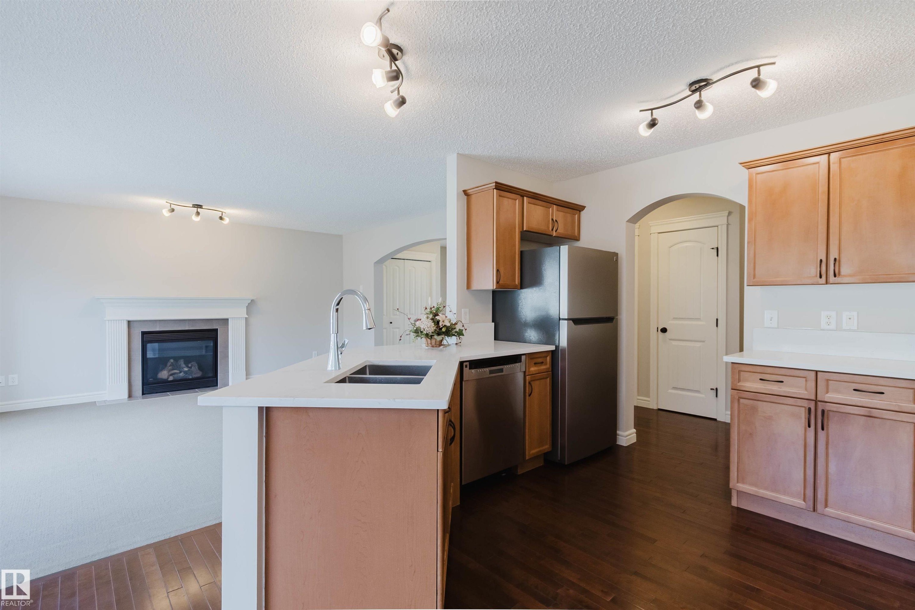 Kitchen island with an undermount sink and gooseneck faucet - 1140 115 Street, Edmonton, AB - Indoor Photo Showing Kitchen With Double Sink
