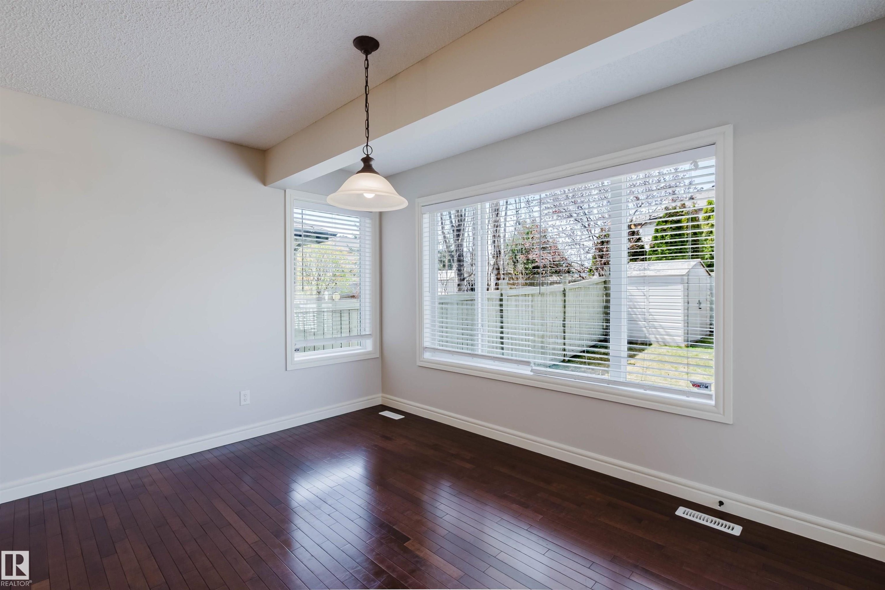 Spacious interior with dark wood-finish flooring - 1140 115 Street, Edmonton, AB - Indoor Photo Showing Other Room