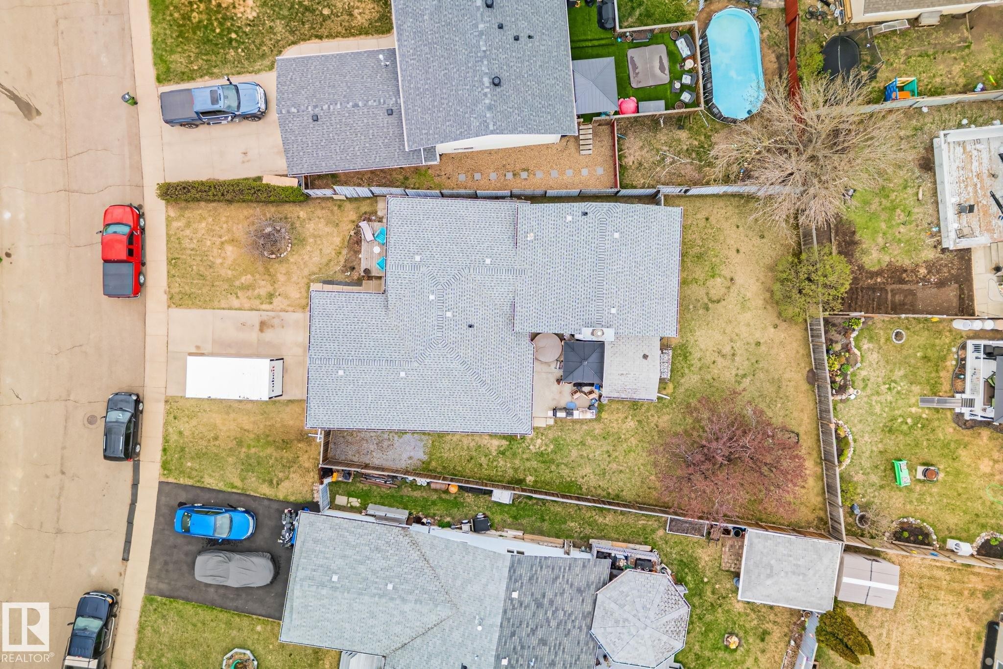 Large lot featuring a main residence with a gray shingle roof, paved driveway, and established landscaping - 4707 10A Avenue, Edmonton, AB - Outdoor