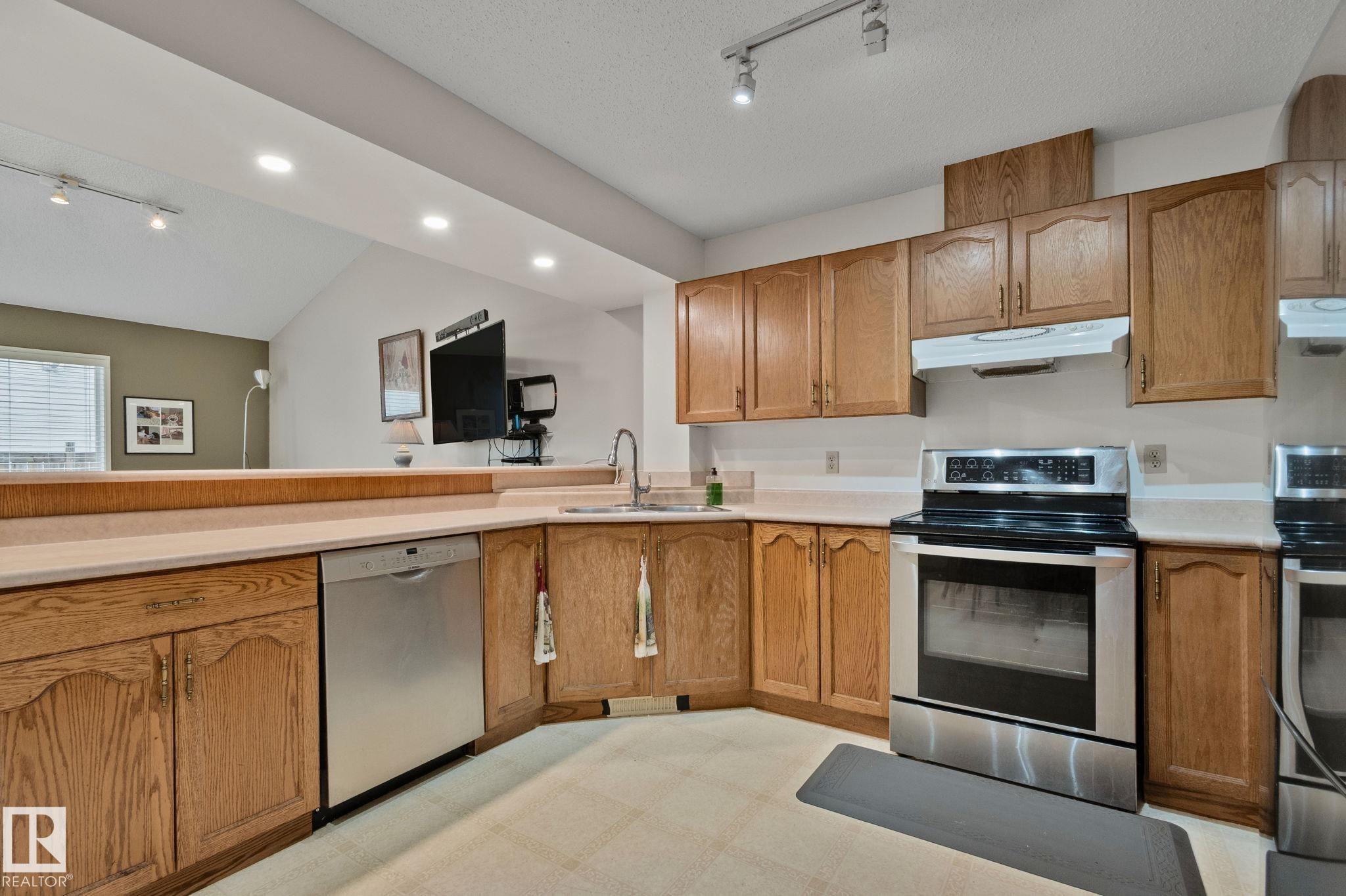 Kitchen featuring light wood cabinetry and light-toned countertops - 4707 10A Avenue, Edmonton, AB - Indoor Photo Showing Kitchen