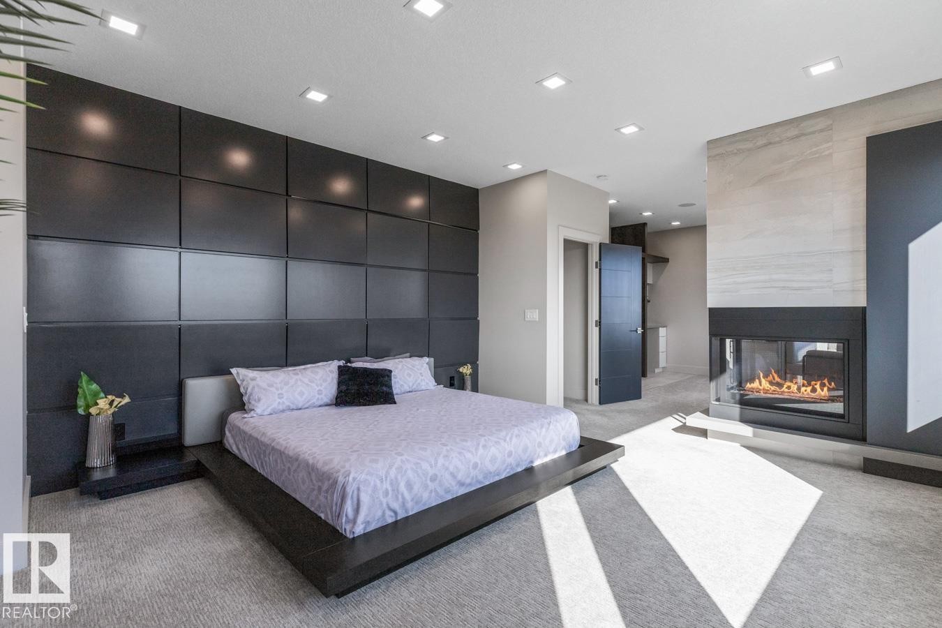 Huge Primary Bedroom featuring Private Sitting room with Wet Bar and Bar Fridge, Huge Ensuite Closet, Three Sided Fireplace, and Ensuite - 5536 Chegwin Point(E), Edmonton, AB - Indoor With Fireplace