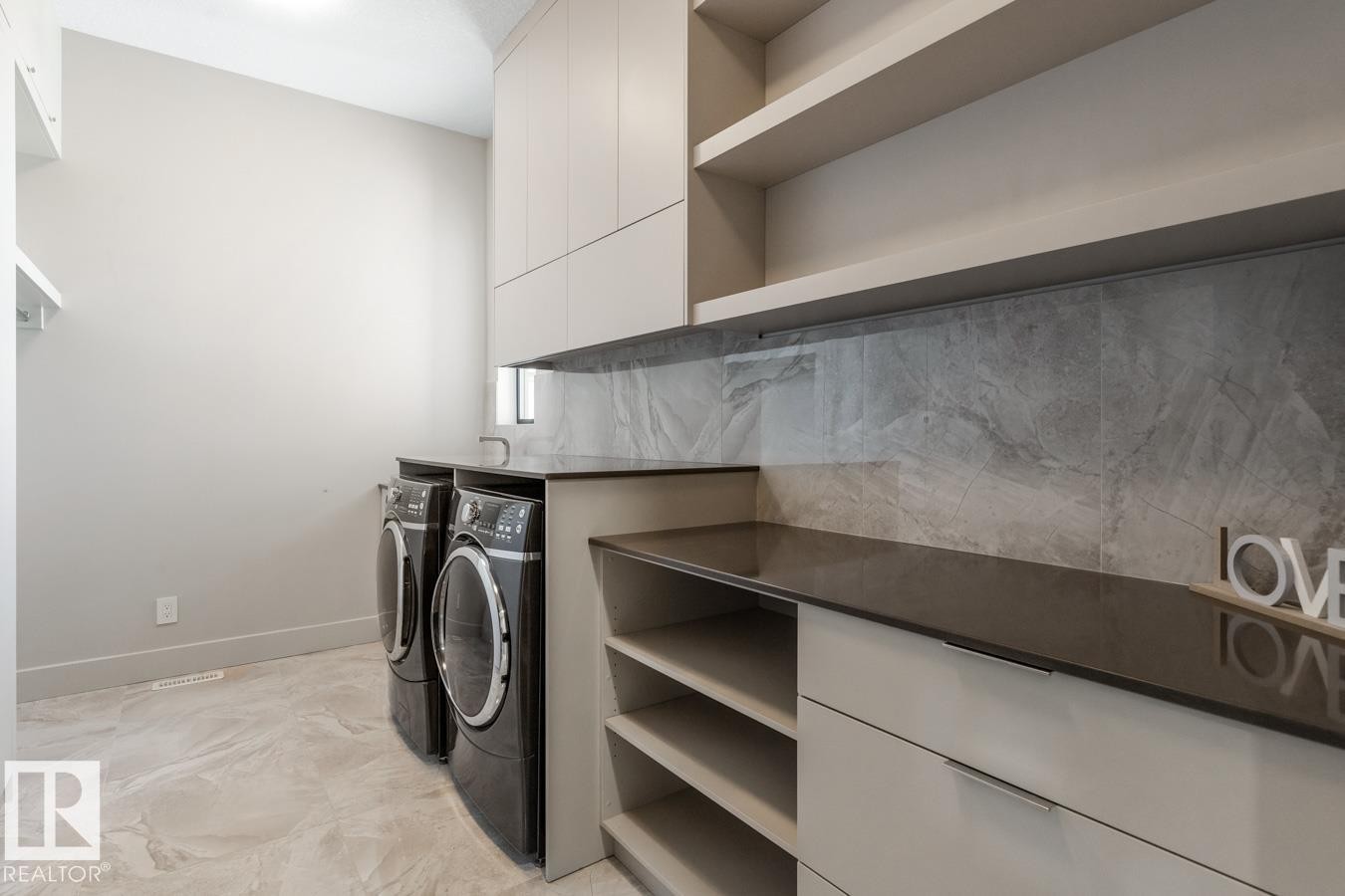 Upstairs Laundry Room featuring ample counter space and storage - 5536 Chegwin Point(E), Edmonton, AB - Indoor Photo Showing Laundry Room