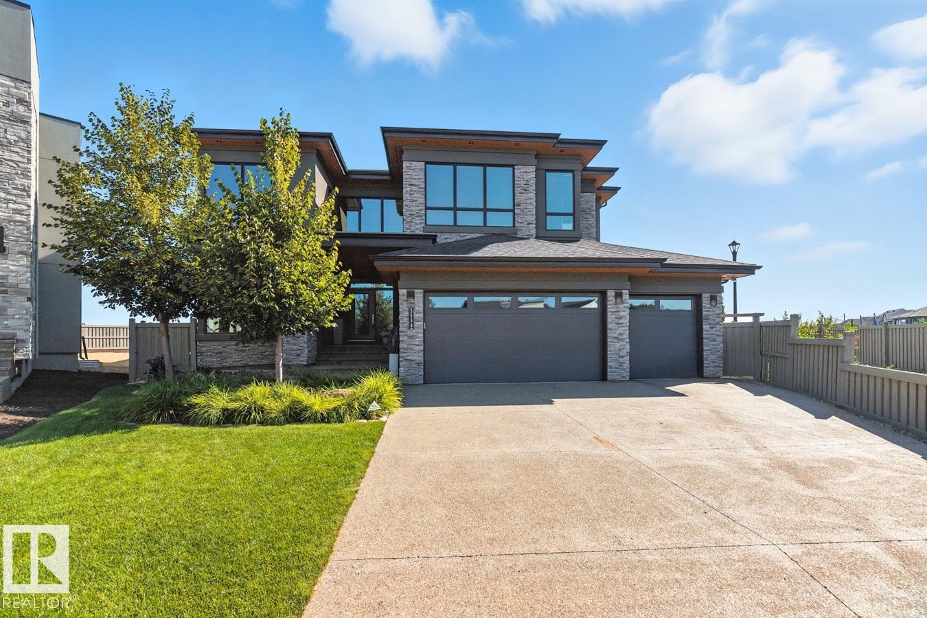 Exterior Front of House showing Oversized Driveway, Triple Car Garage, and Siding on to Walking Path - 5536 Chegwin Point(E), Edmonton, AB - Outdoor