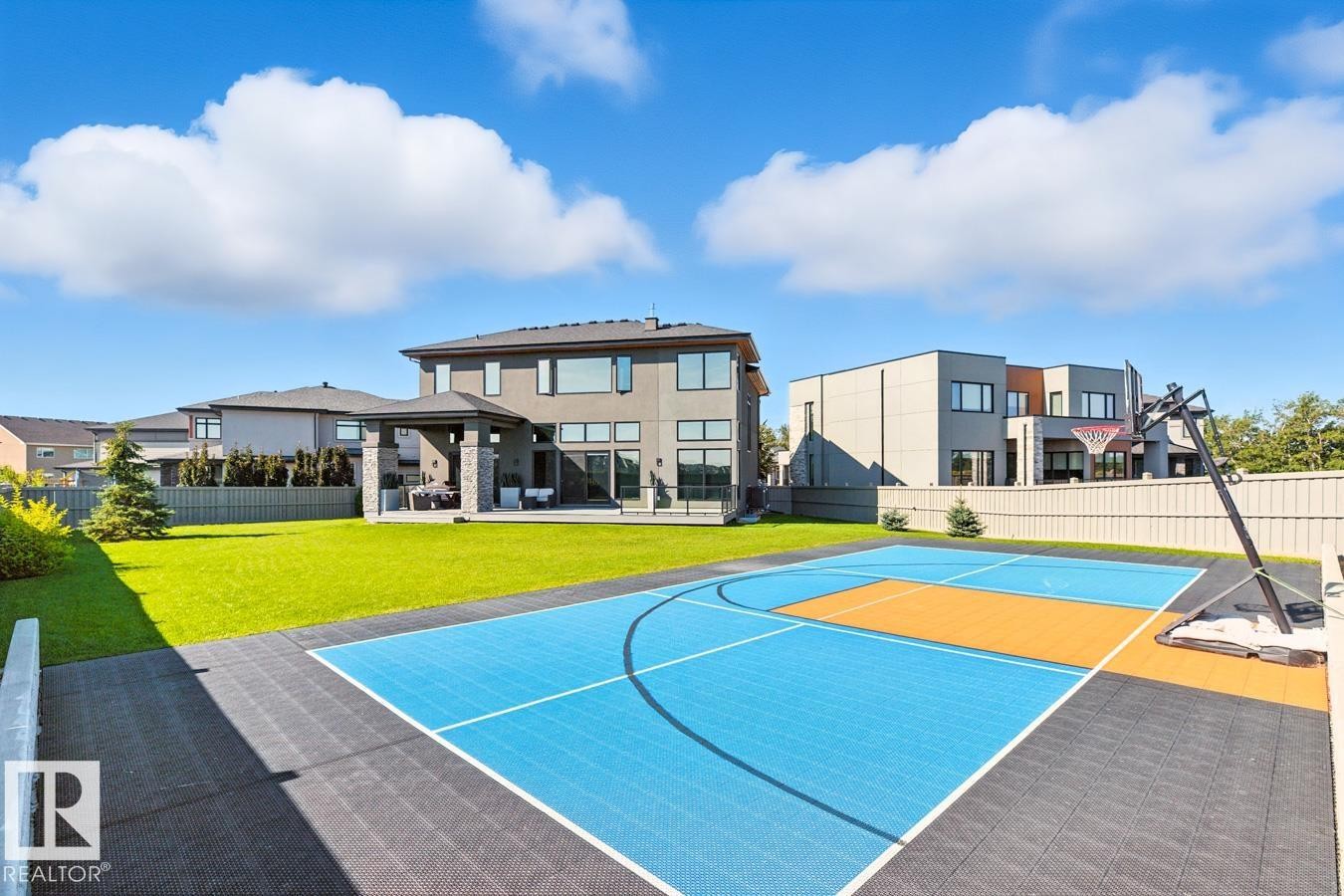 North East Facing Back yard featuring Covered Deck with Composite Boards, Ample Grass Space, Pickle Ball/Basketball Court, Fully Landscaped, and Fully Fenced. - 5536 Chegwin Point(E), Edmonton, AB - Outdoor With In Ground Pool With Backyard