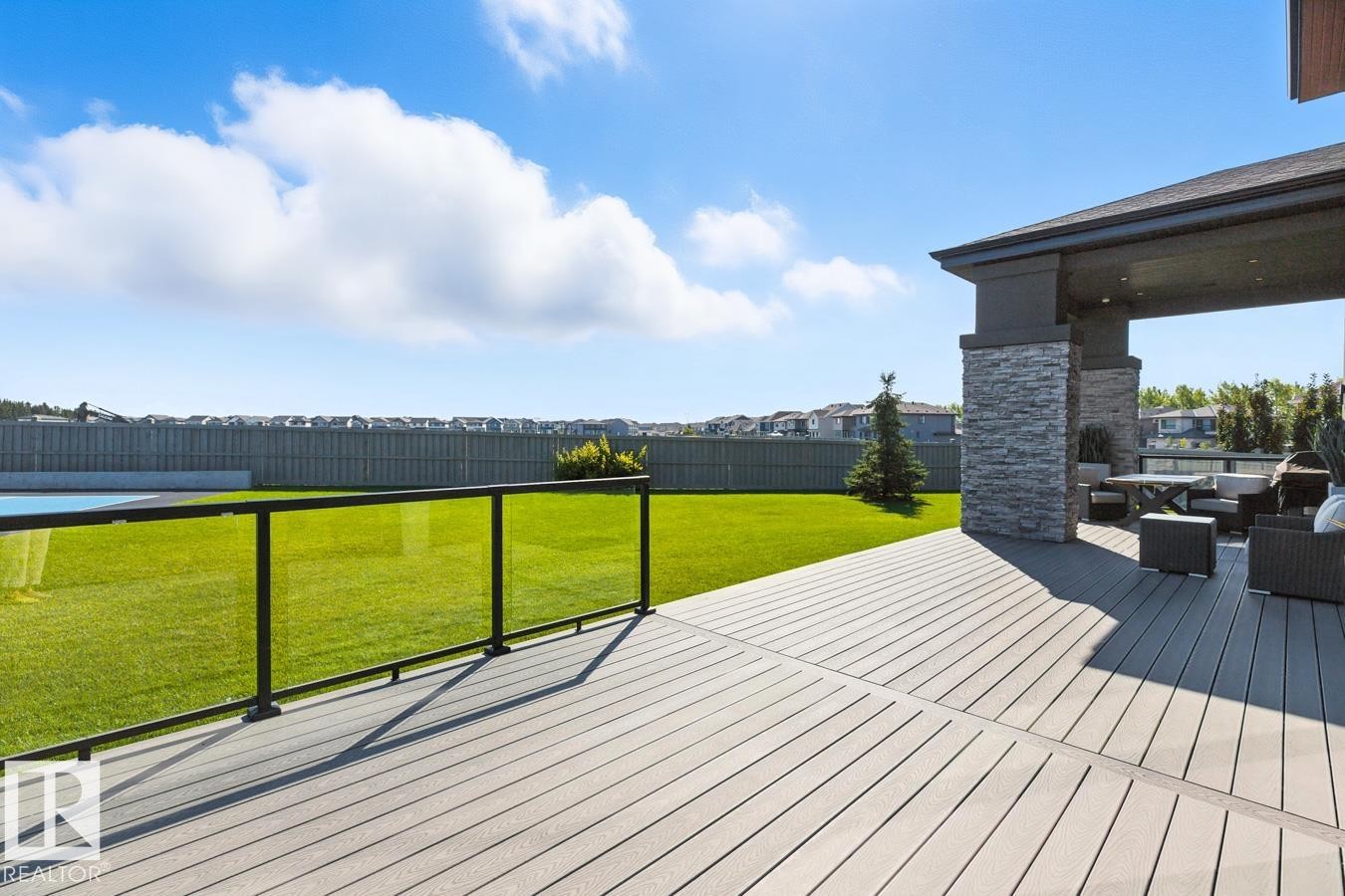North East Facing Back yard featuring Covered Deck with Composite Boards, Ample Grass Space, Pickle Ball/Basketball Court, Fully Landscaped, and Fully Fenced. - 5536 Chegwin Point(E), Edmonton, AB - Outdoor