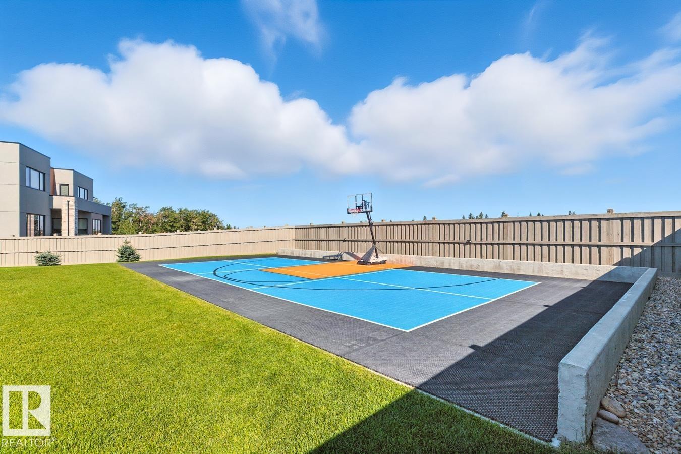 North East Facing Back yard featuring Covered Deck with Composite Boards, Ample Grass Space, Pickle Ball/Basketball Court, Fully Landscaped, and Fully Fenced. - 5536 Chegwin Point(E), Edmonton, AB - Outdoor With In Ground Pool