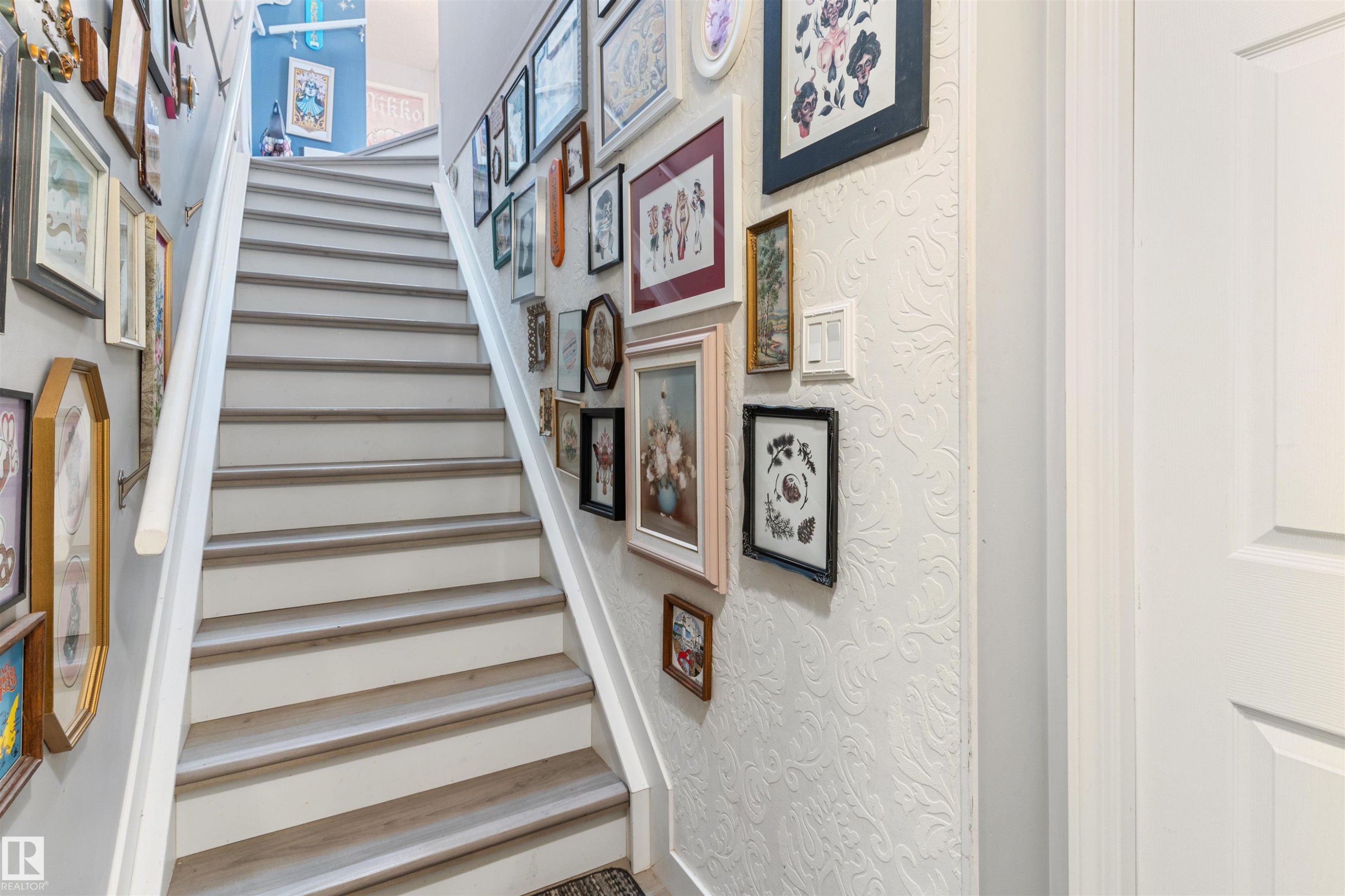 Staircase featuring wood-finish treads, white risers, and a white handrail - 73 3040 Spence Wynd, Edmonton, AB - Indoor Photo Showing Other Room