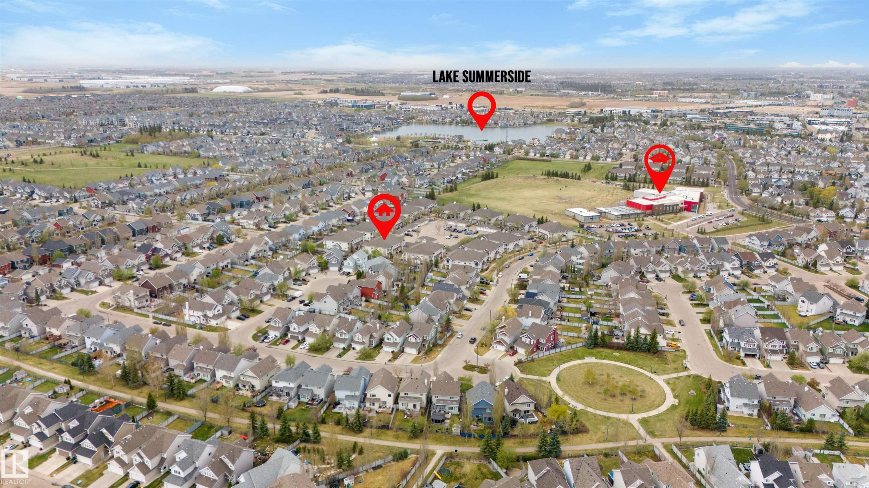 Aerial perspective of a developed residential neighborhood featuring numerous single-family homes and a central green space - 73 3040 Spence Wynd, Edmonton, AB - Outdoor With View