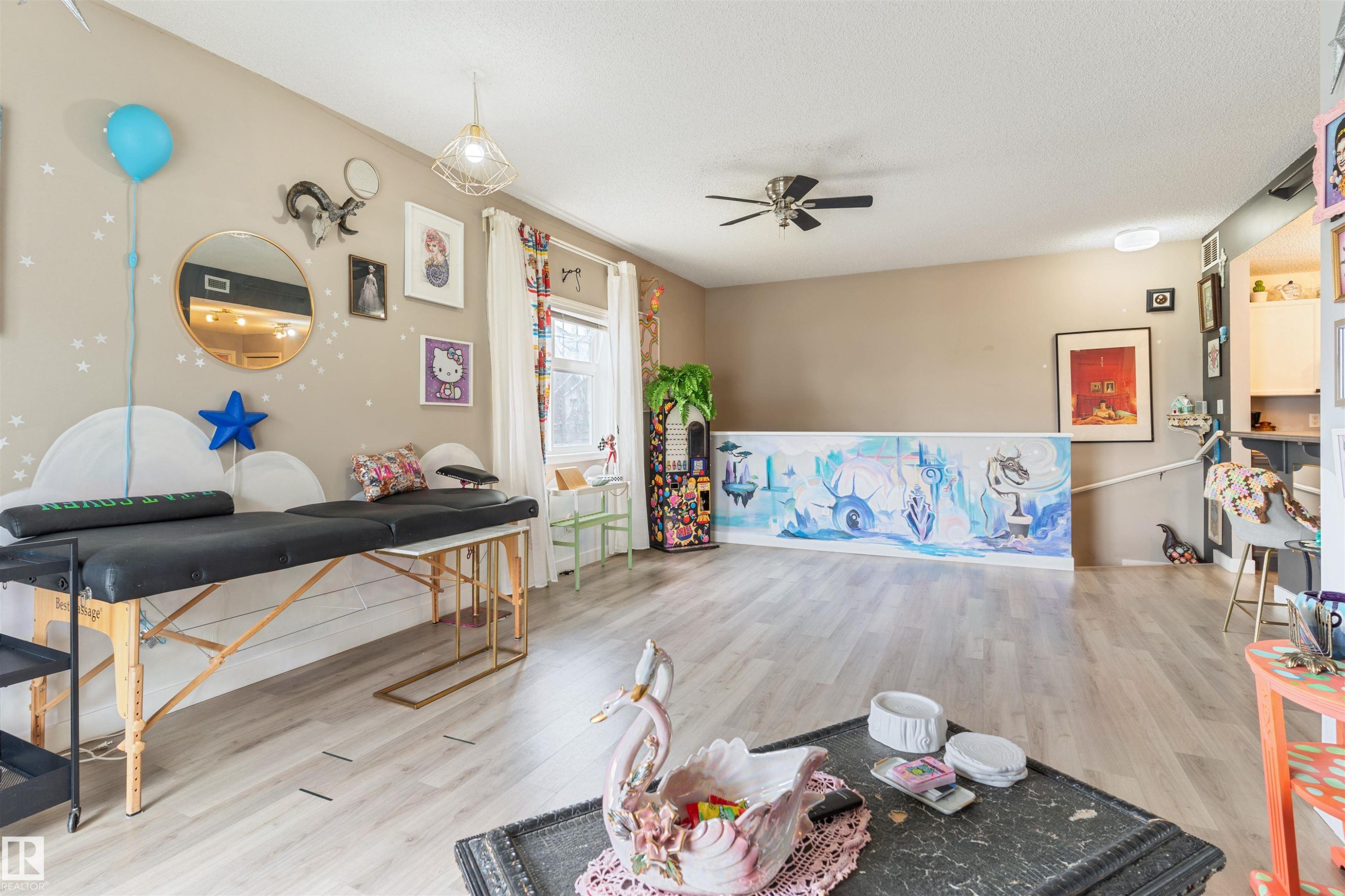 Spacious room featuring wood-finish flooring, a ceiling fan, and recessed lighting - 73 3040 Spence Wynd, Edmonton, AB - Indoor