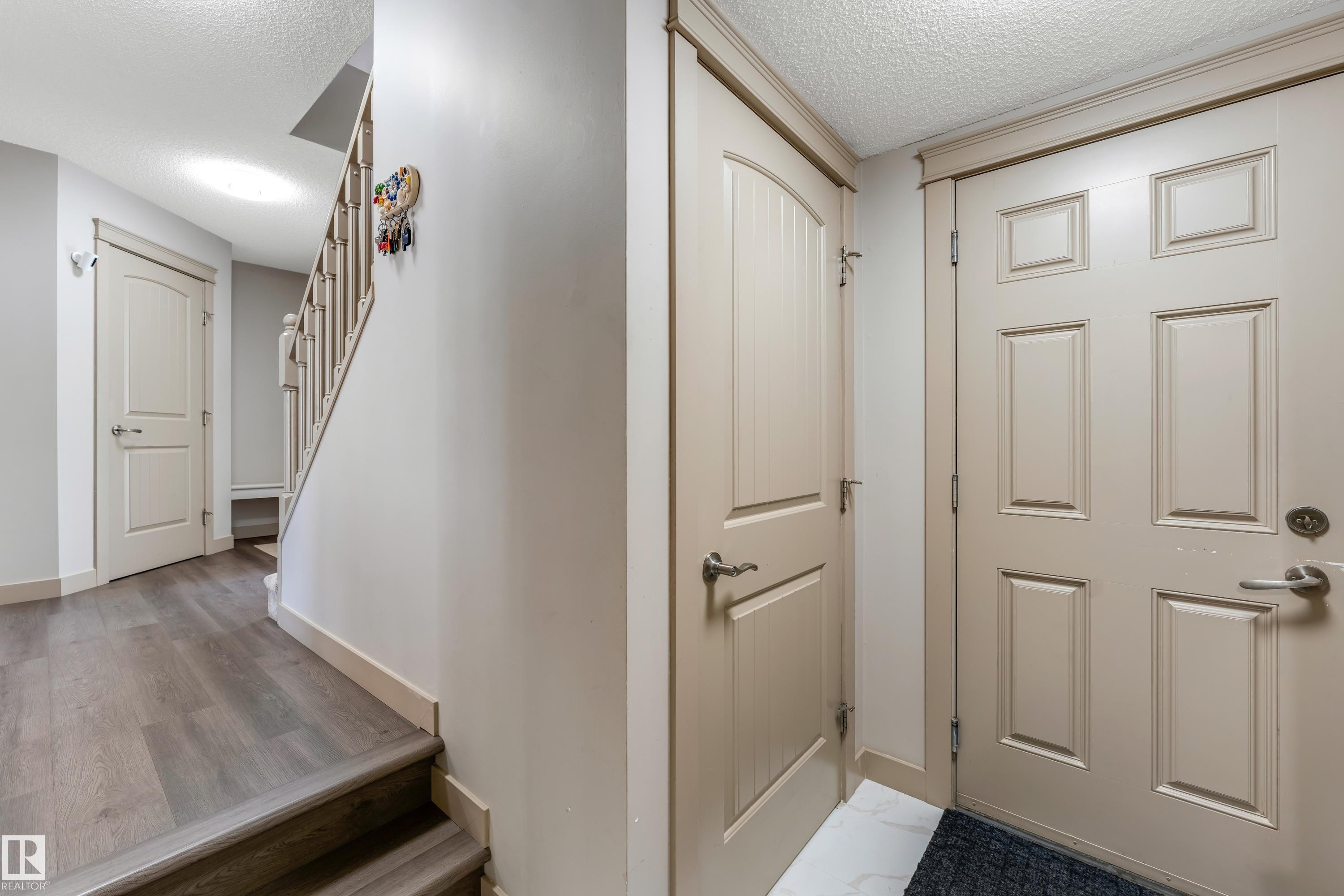 The entry features a paneled door and light-colored walls - 463 Tamarack Green, Edmonton, AB - Indoor Photo Showing Other Room