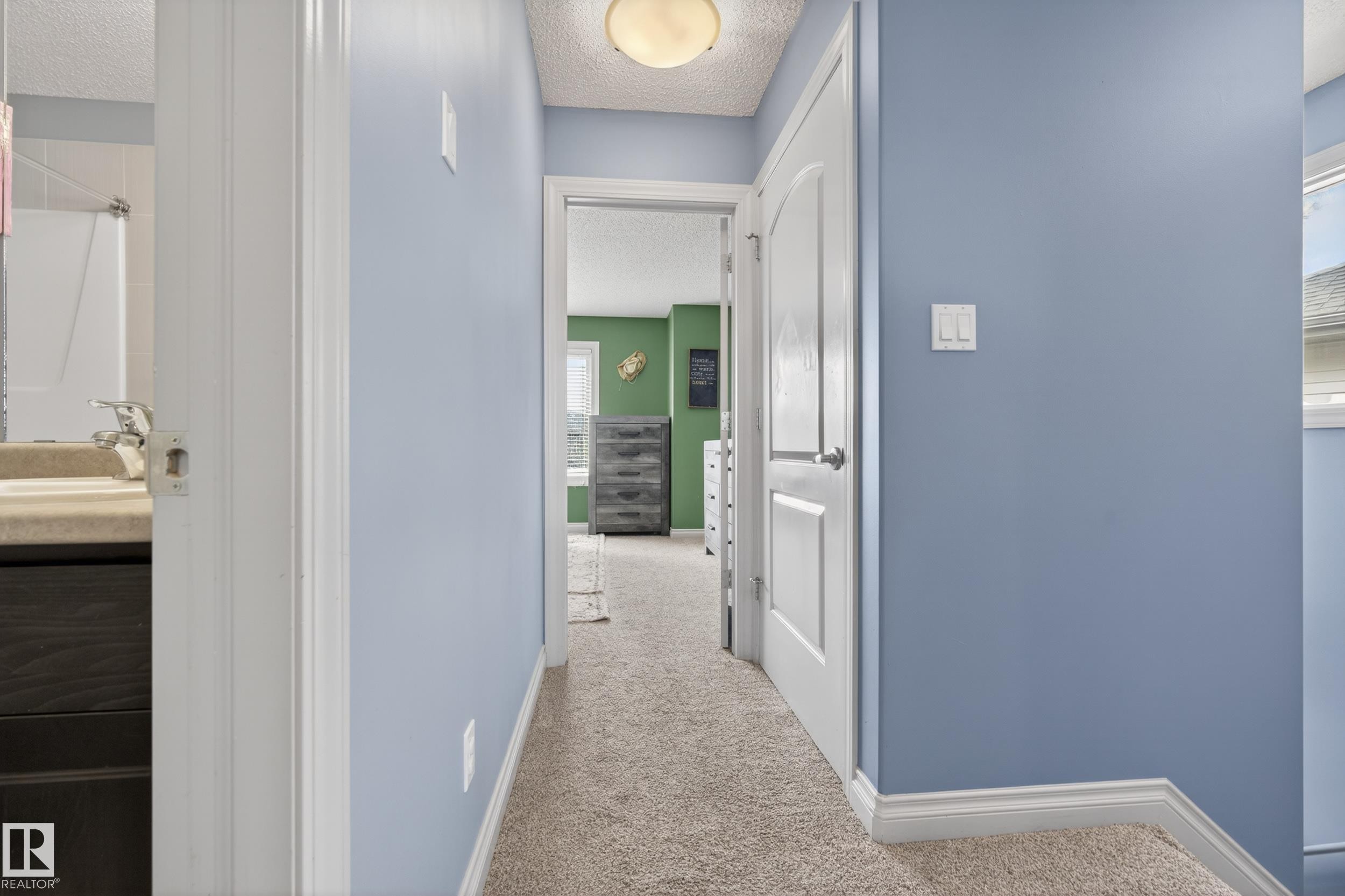 Carpeted hallway with light blue walls and white trim - 7074 Cardinal Way, Edmonton, AB - Indoor Photo Showing Other Room