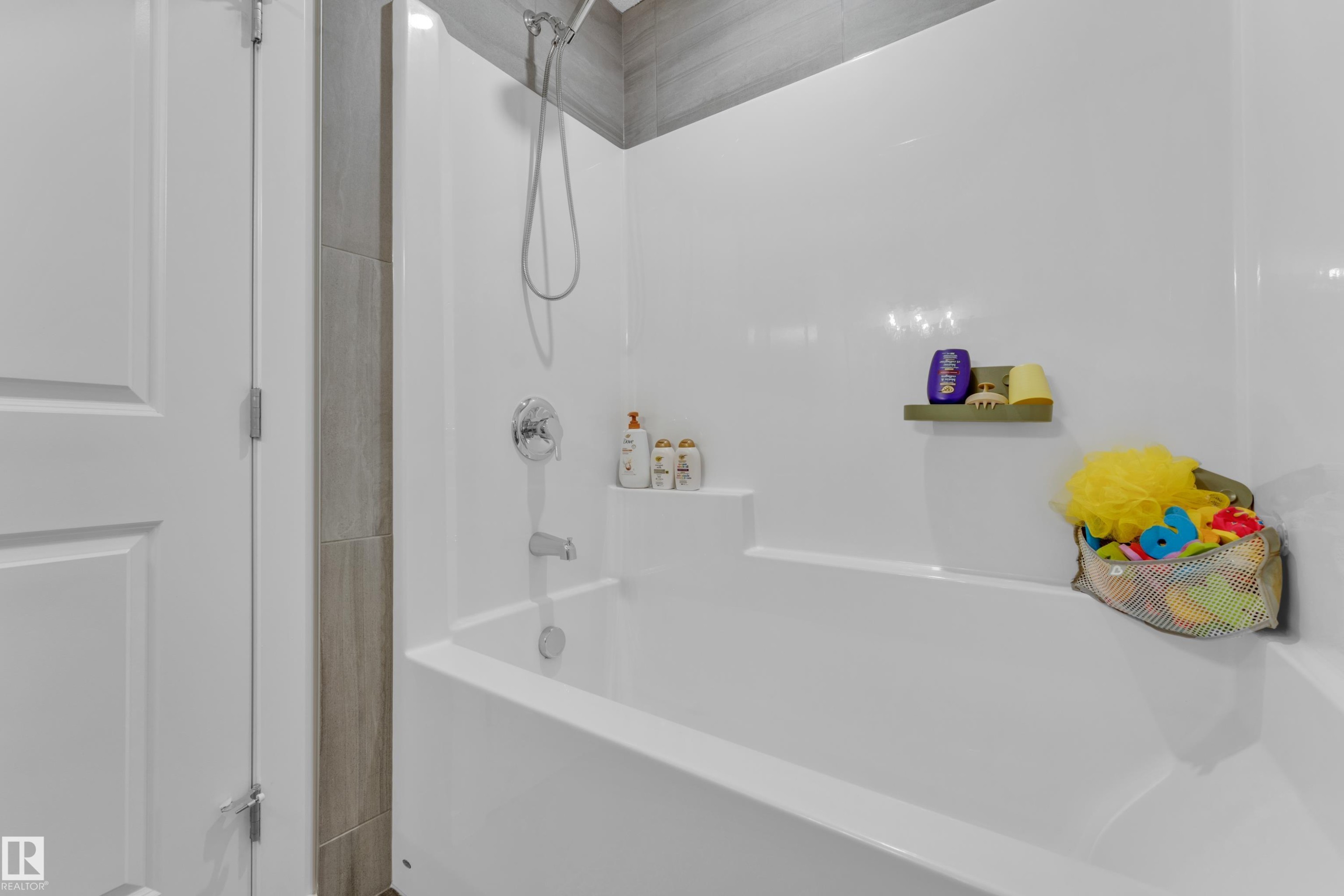 Bathtub with white surround and chrome fixtures - 17319 2 St Nw, Edmonton, AB - Indoor Photo Showing Bathroom