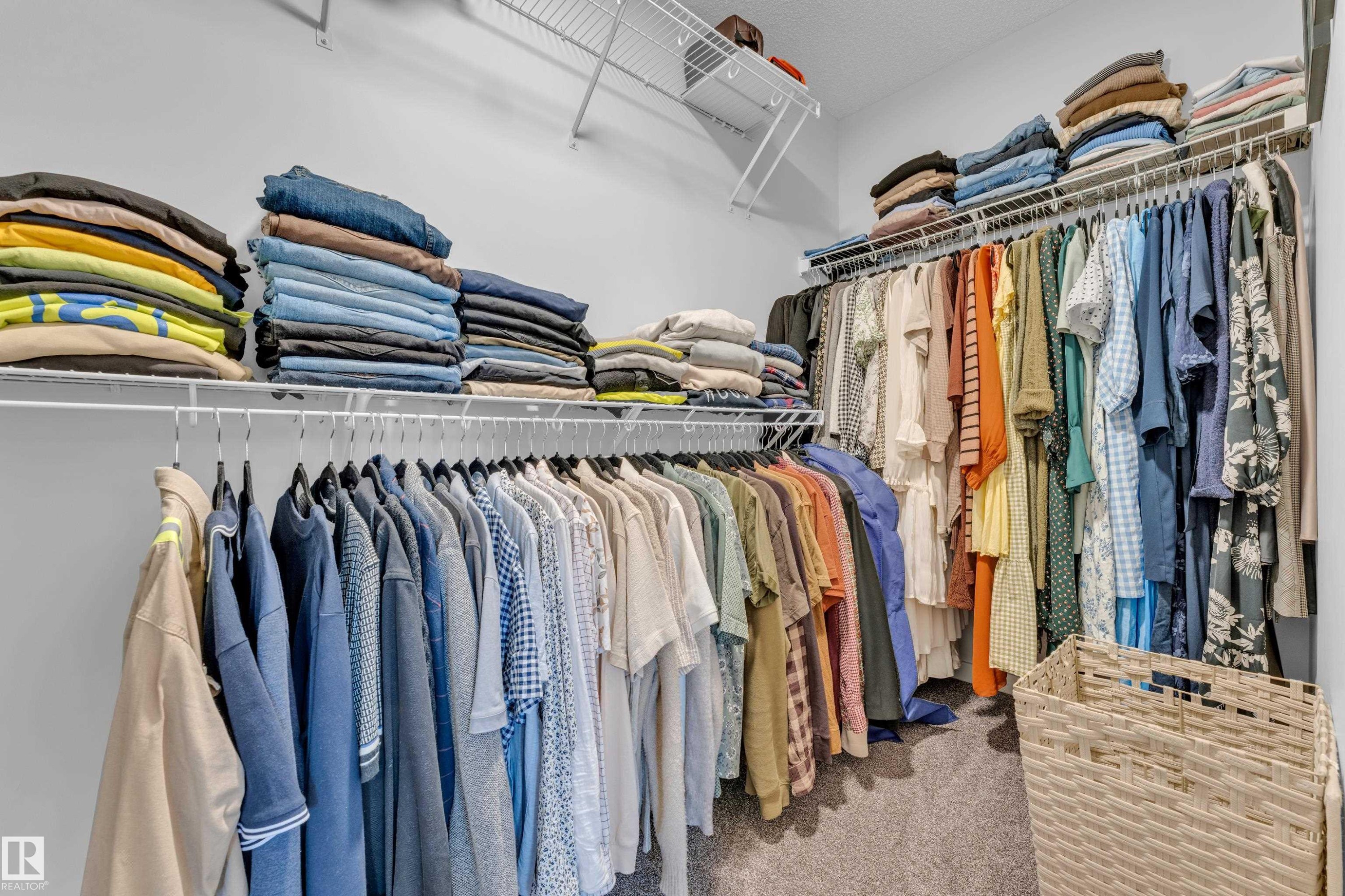 Well-appointed closet featuring white wire shelving and hanging rods - 17319 2 St Nw, Edmonton, AB - Indoor With Storage