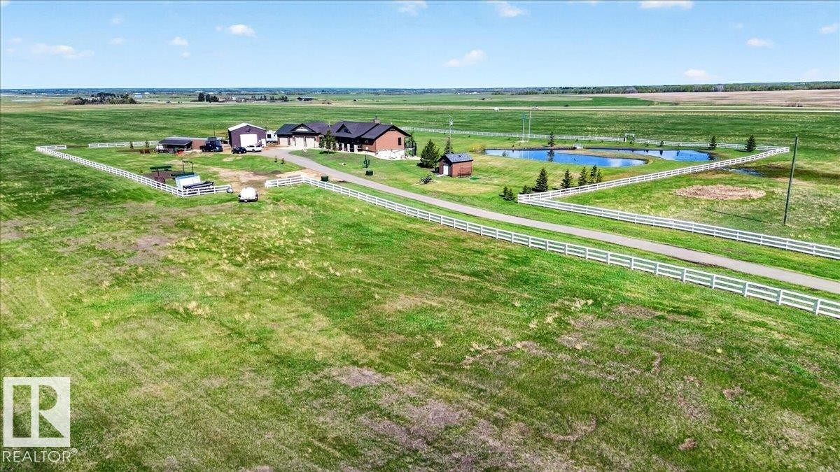 This versatile room features expansive windows and sliding glass doors, offering abundant natural light and exterior views - 531064 Range Road 174, Rural Lamont County, AB - Indoor