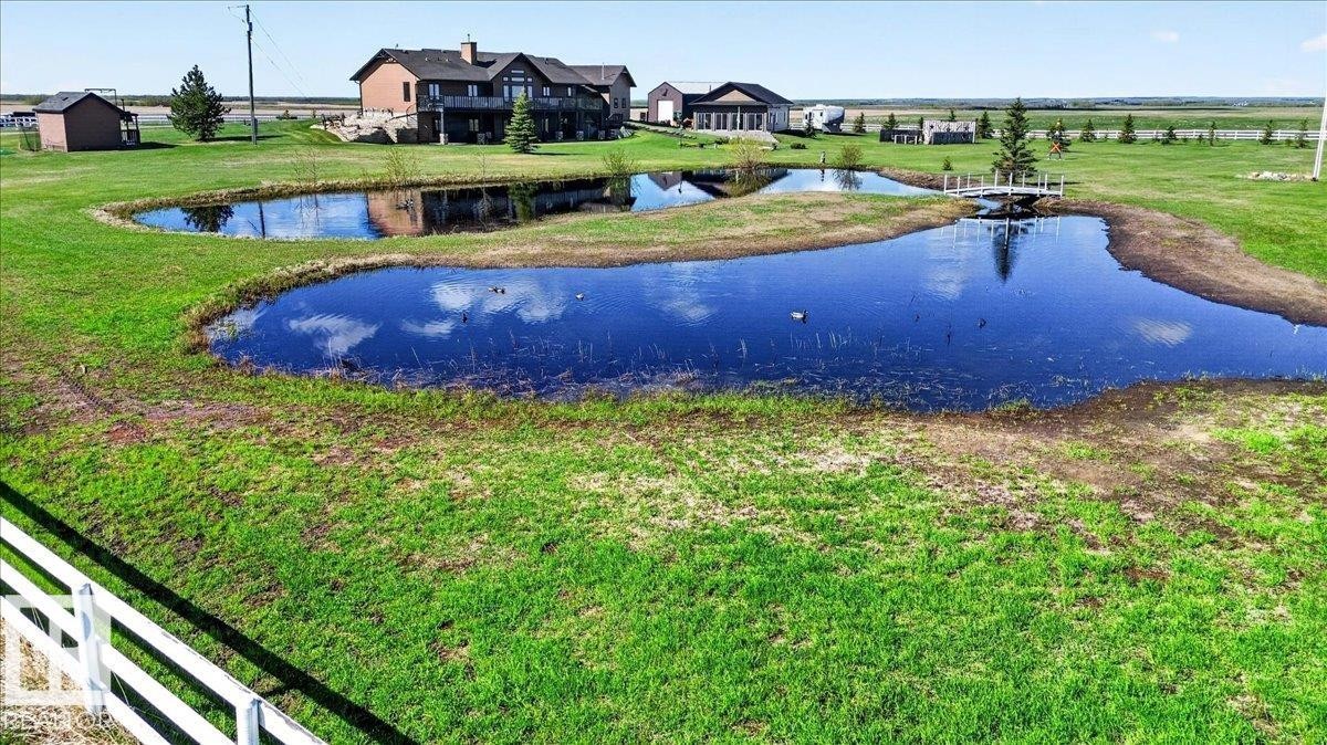 Expansive property featuring several structures, including a main residence and a detached building, set against a vast, open landscape - 531064 Range Road 174, Rural Lamont County, AB - Outdoor With View