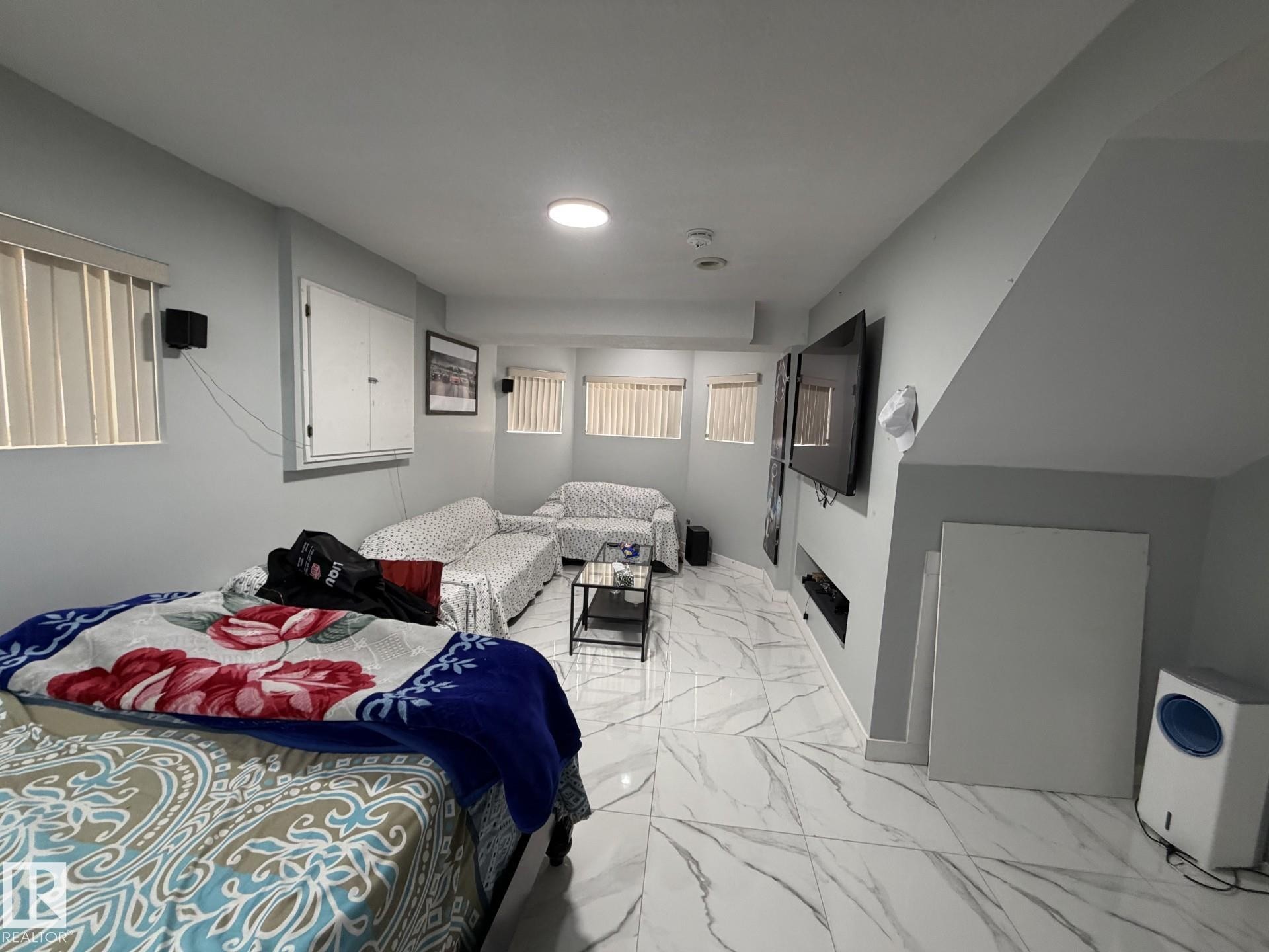 Spacious room featuring white marble-look tile flooring and light gray walls - 3139 34B Avenue, Edmonton, AB - Indoor Photo Showing Bedroom