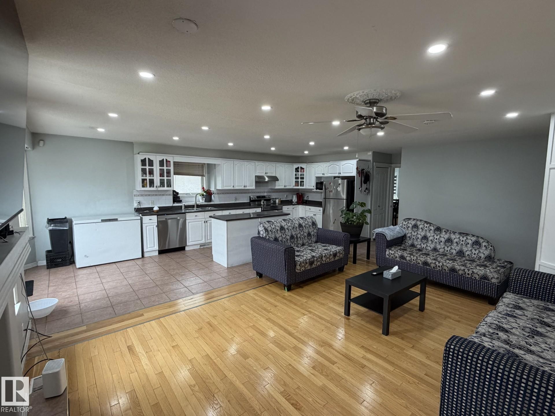 Open-concept living space featuring wood-finish flooring, recessed lighting, and a ceiling fan - 3139 34B Avenue, Edmonton, AB - Indoor
