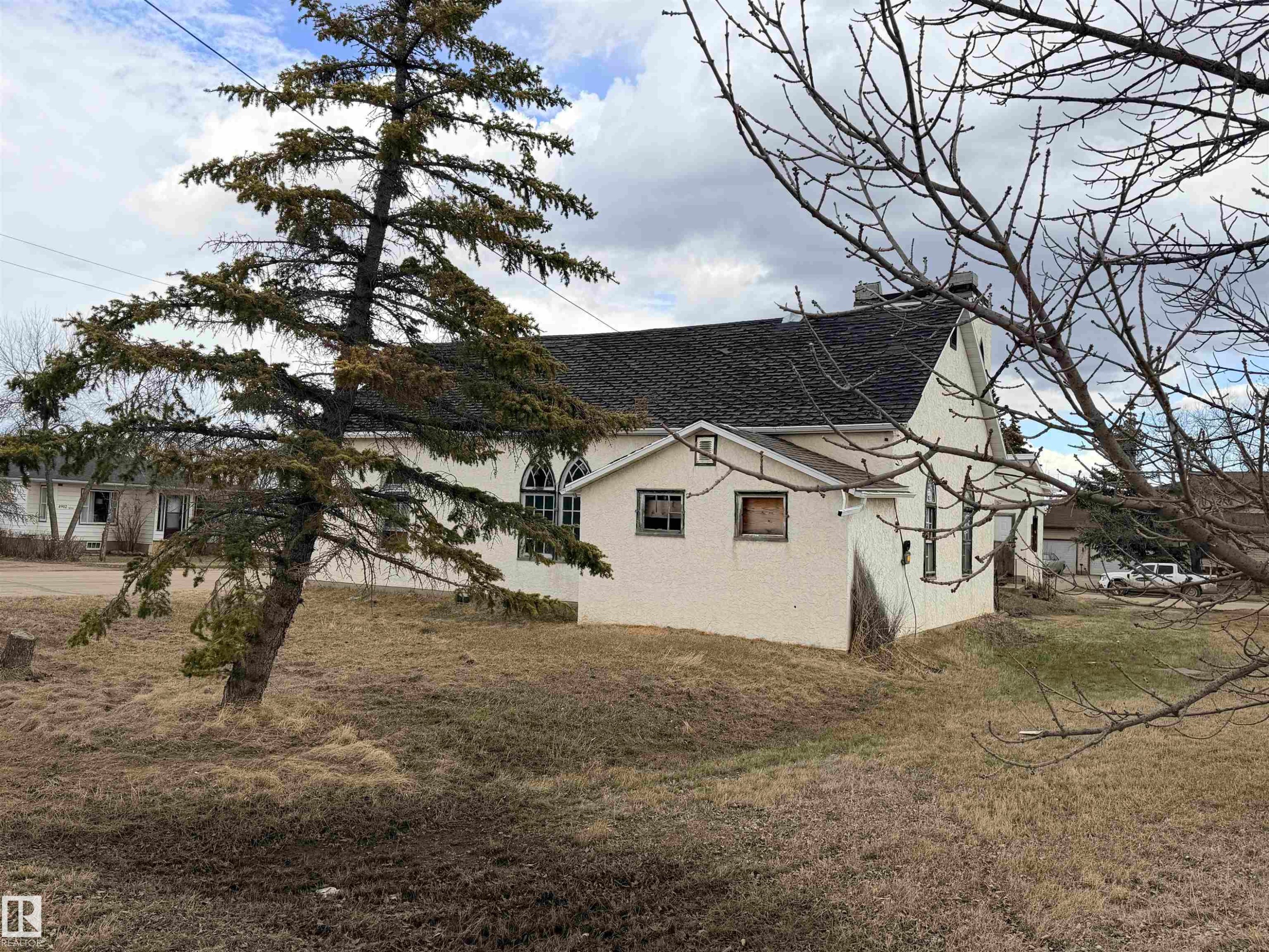 Stucco exterior with a pitched roof - 5036 49 Street, Clyde, AB - Outdoor