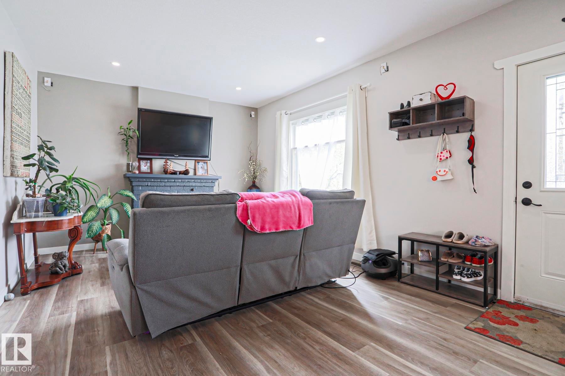 Living area with wood-finish flooring and recessed lighting - 5113 53 Avenue, Stony Plain, AB - Indoor