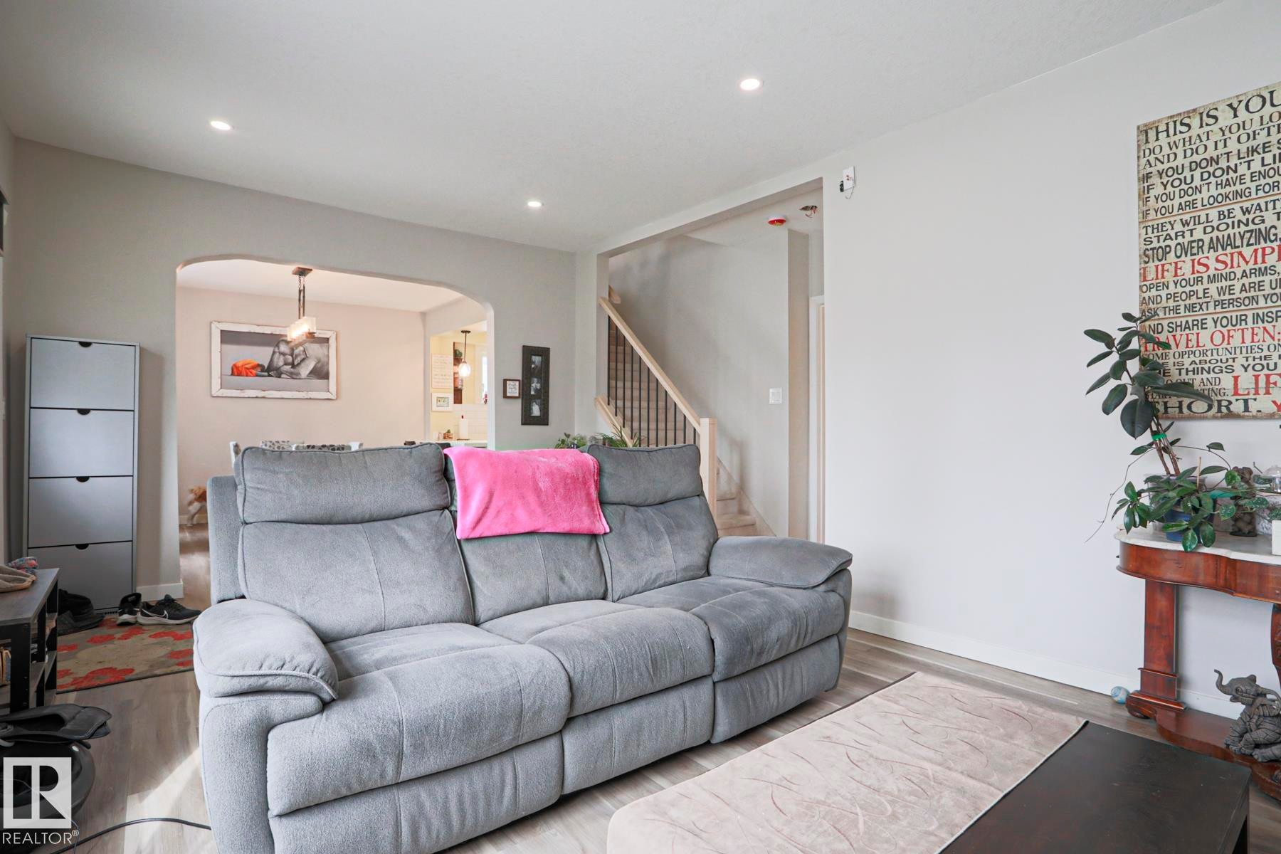 Living space featuring wood-finish flooring, recessed lighting, and a neutral color palette - 5113 53 Avenue, Stony Plain, AB - Indoor Photo Showing Living Room