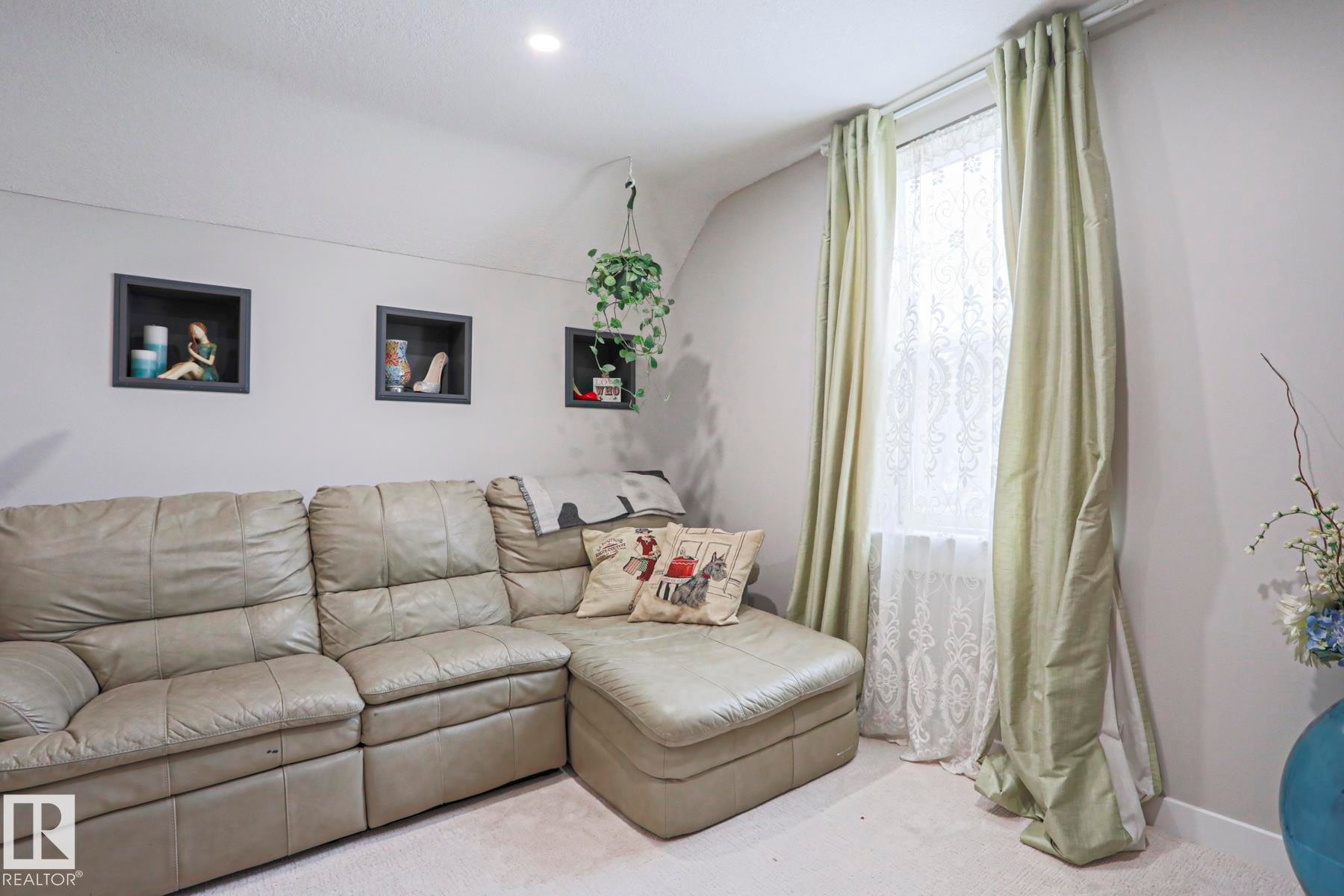 Recessed lighting illuminates a space featuring three wall-mounted display niches - 5113 53 Avenue, Stony Plain, AB - Indoor Photo Showing Living Room