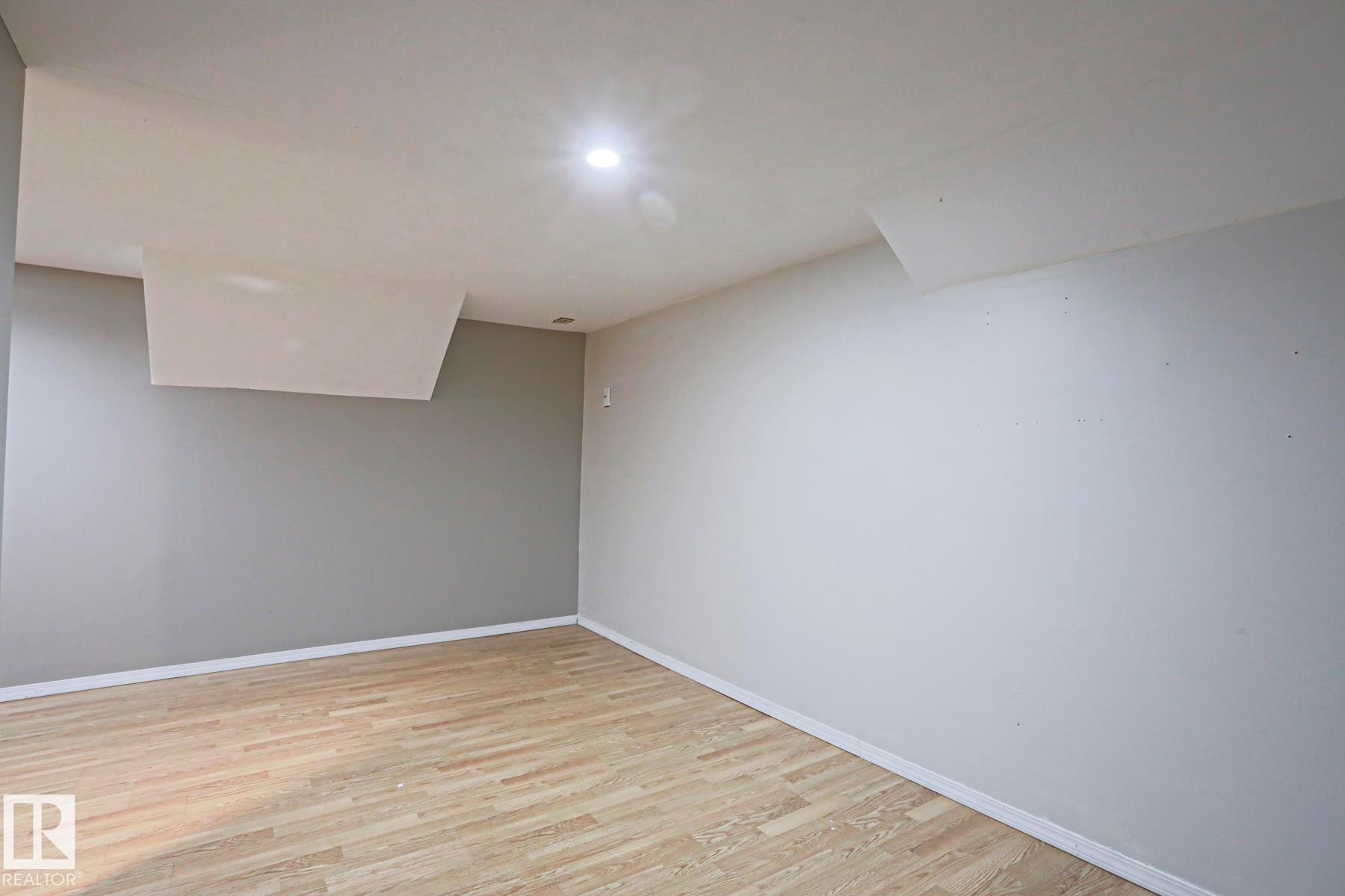 Room featuring light wood-finish flooring and recessed ceiling lighting - 5113 53 Avenue, Stony Plain, AB - Indoor Photo Showing Other Room