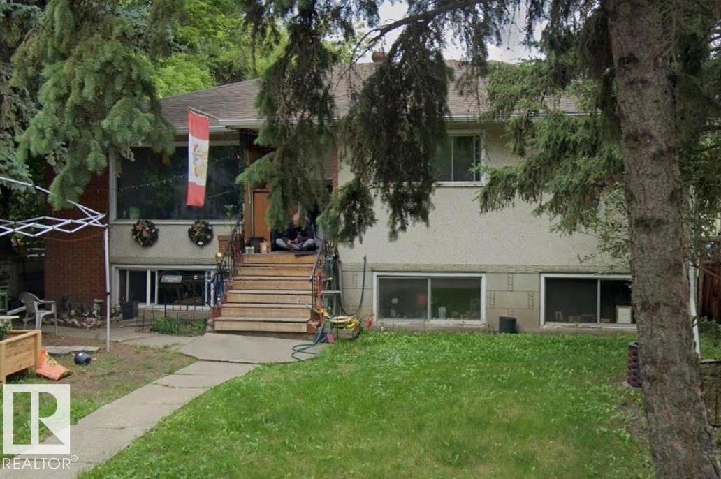 Split-level residence featuring a brick facade and stucco siding - 10450 69 Avenue, Edmonton, AB - Outdoor