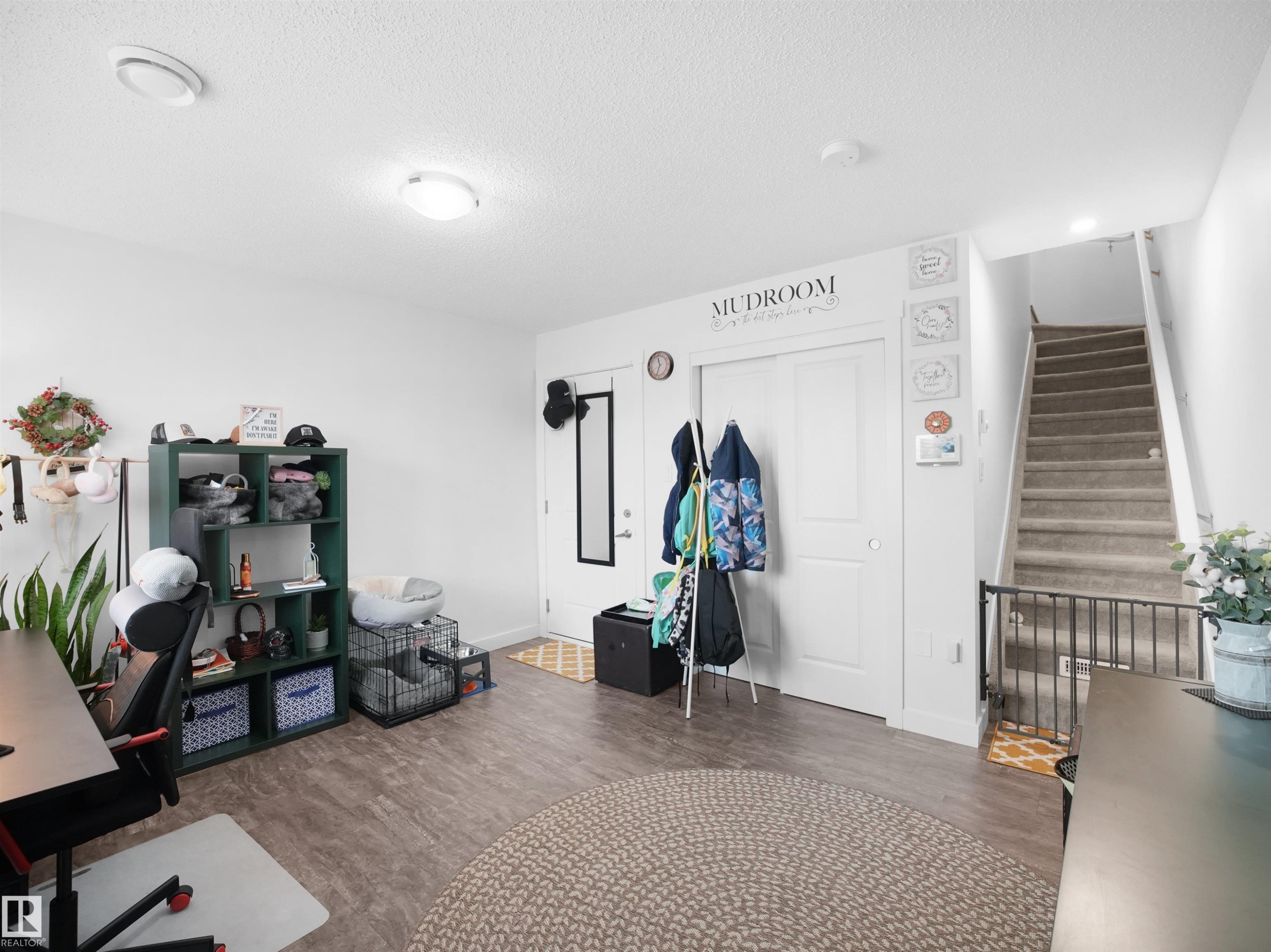 This versatile space features durable flooring, a well-lit entrance, and a visible staircase - 64 655 Watt Boulevard, Edmonton, AB - Indoor