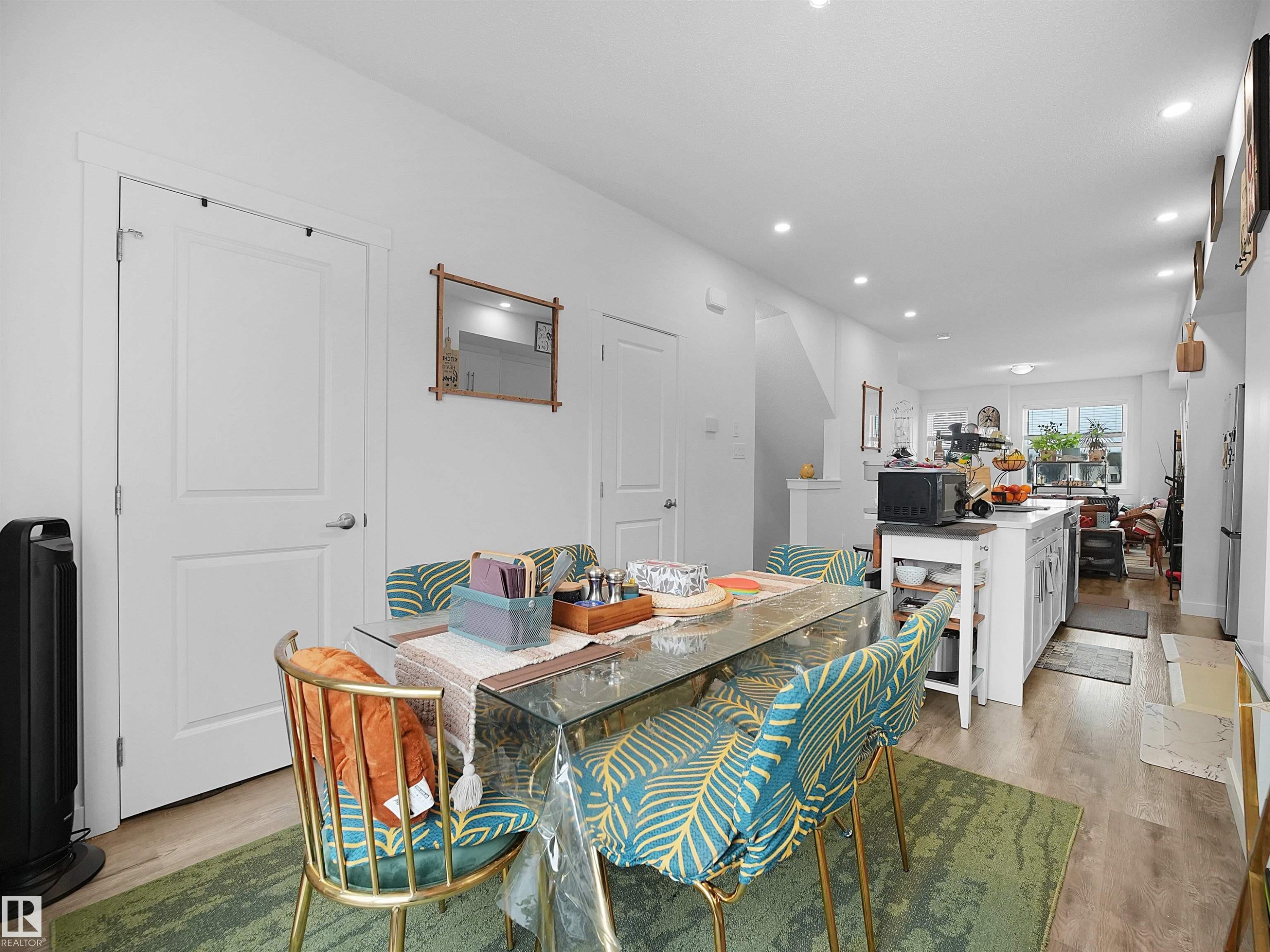 The open-concept living space features light-colored flooring, white walls, and recessed lighting - 64 655 Watt Boulevard, Edmonton, AB - Indoor Photo Showing Dining Room