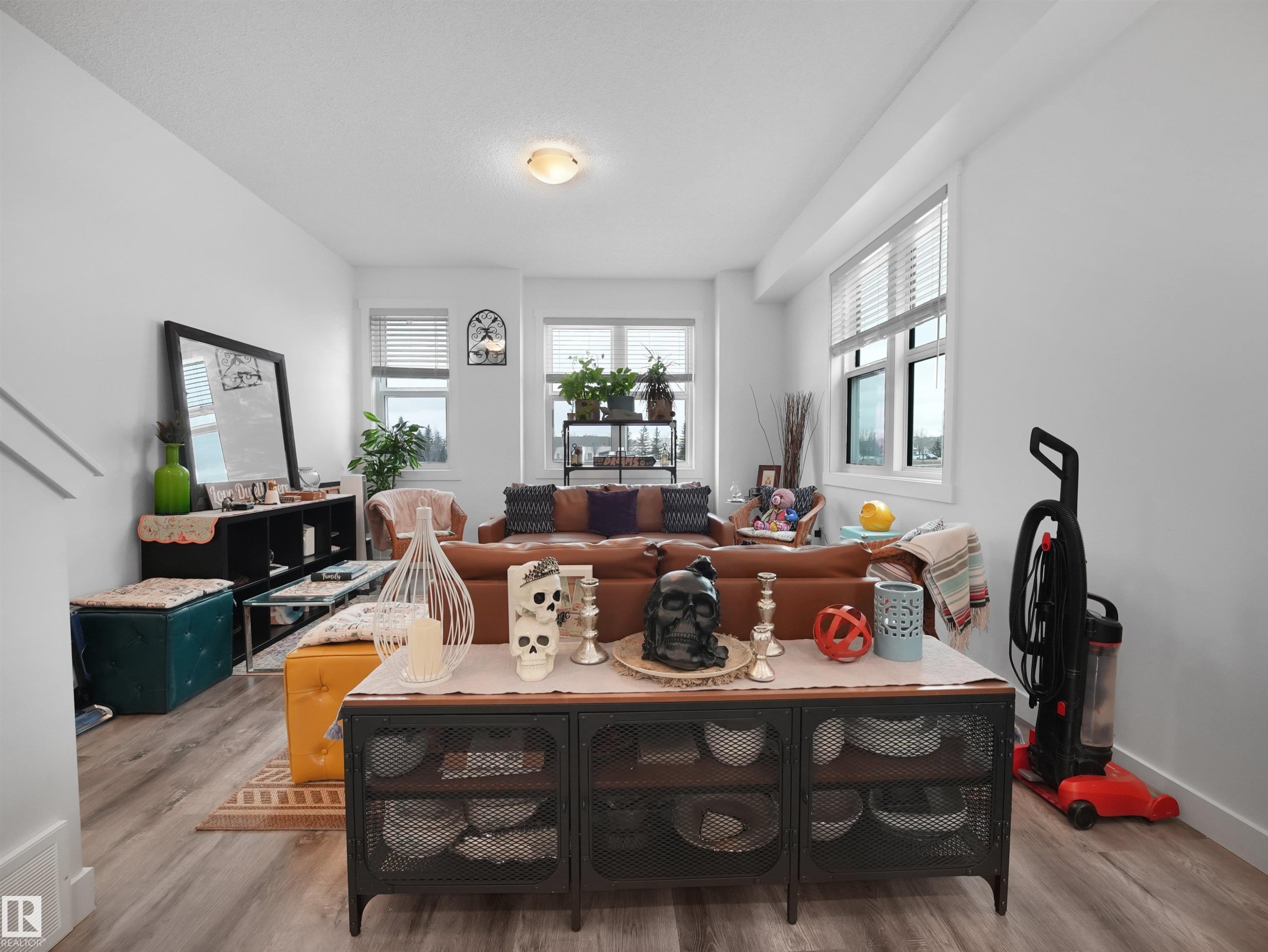 The living room features light-toned flooring and white walls, creating a bright and airy atmosphere - 64 655 Watt Boulevard, Edmonton, AB - Indoor